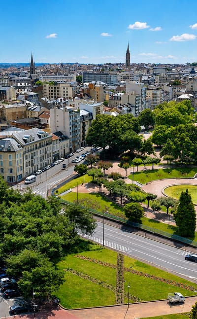 Aerial view of Limoges, France, with the Champ de Juillet park fountain, railway lines and cathedral spires beyond