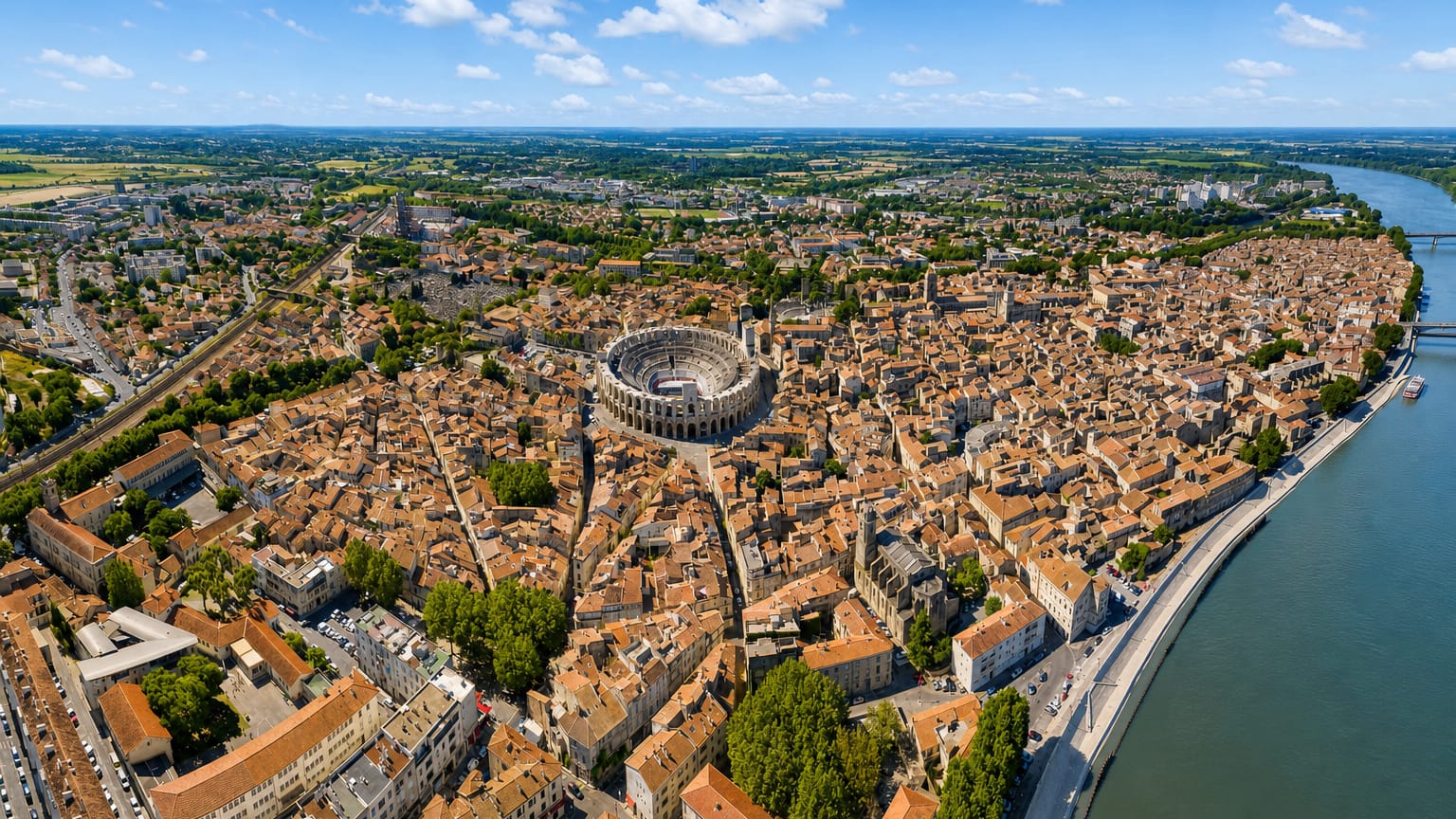 Aerial view of Arles with the Roman amphitheatre at its centre and the Rhone curving past the old town
