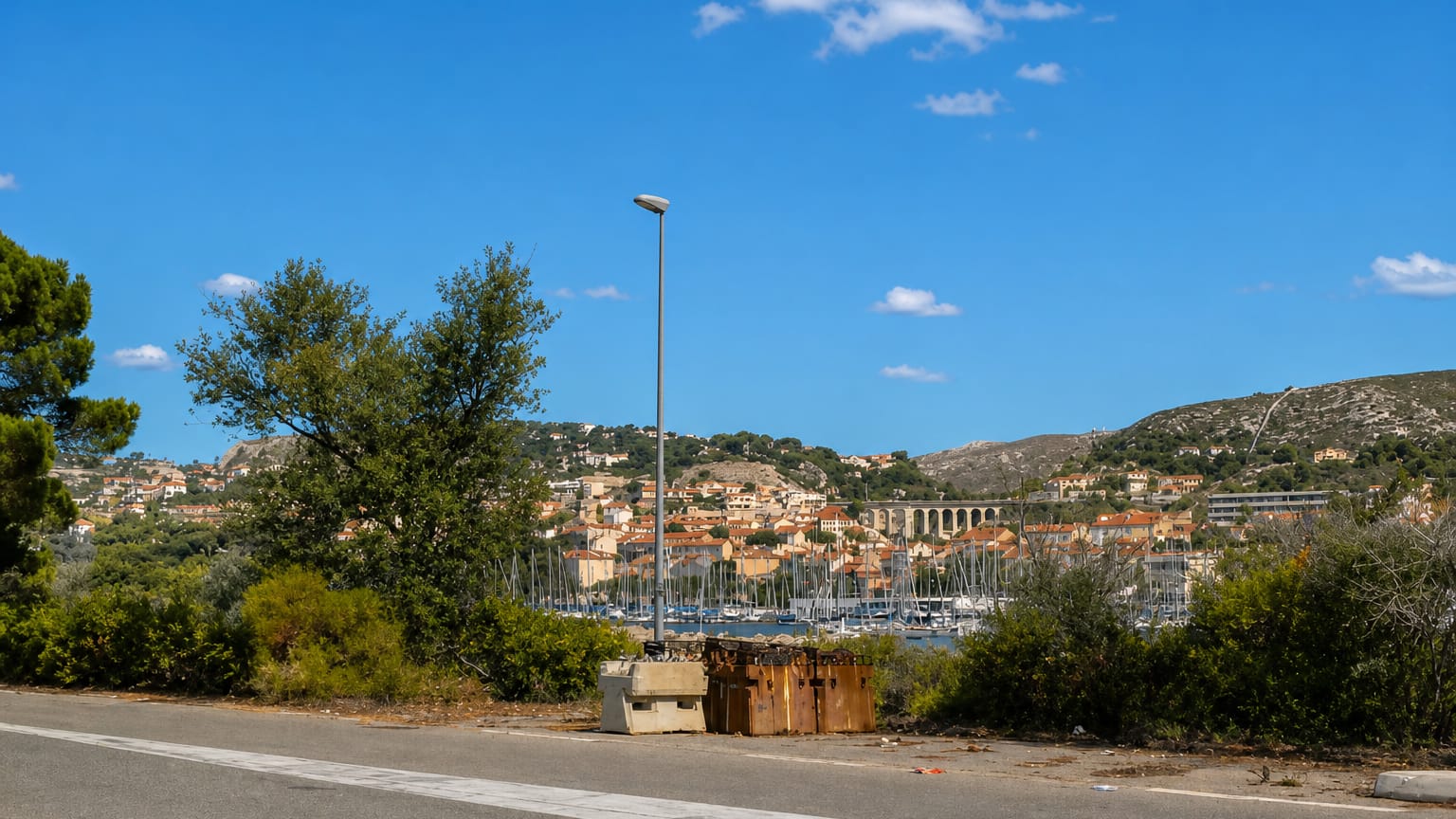 The harbour and railway viaduct of L'Estaque, a fishing district of northern Marseille, seen from a hillside road.