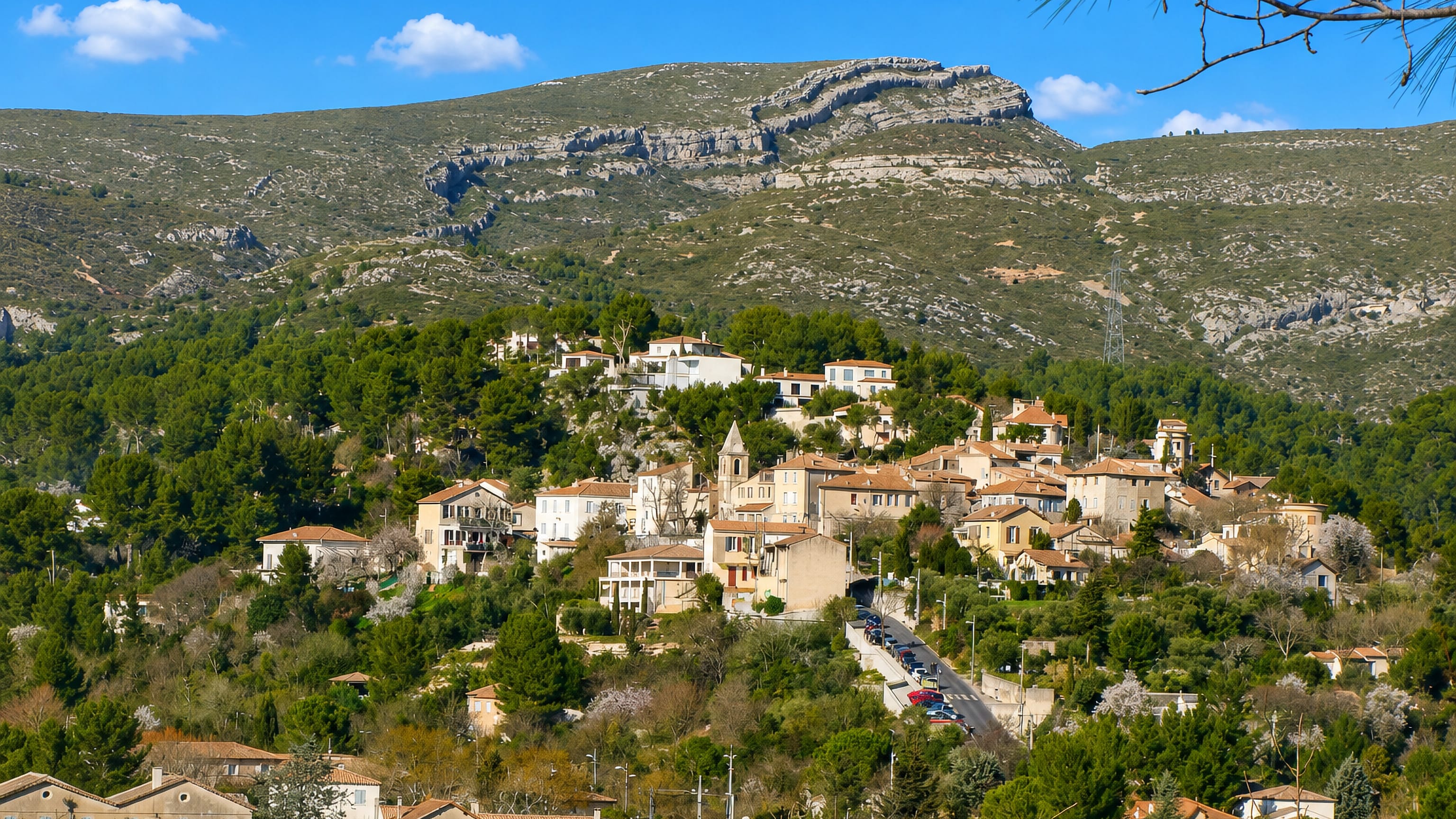 The hilltop village of La Treille in Marseille, its church tower among pines below the Garlaban ridge.