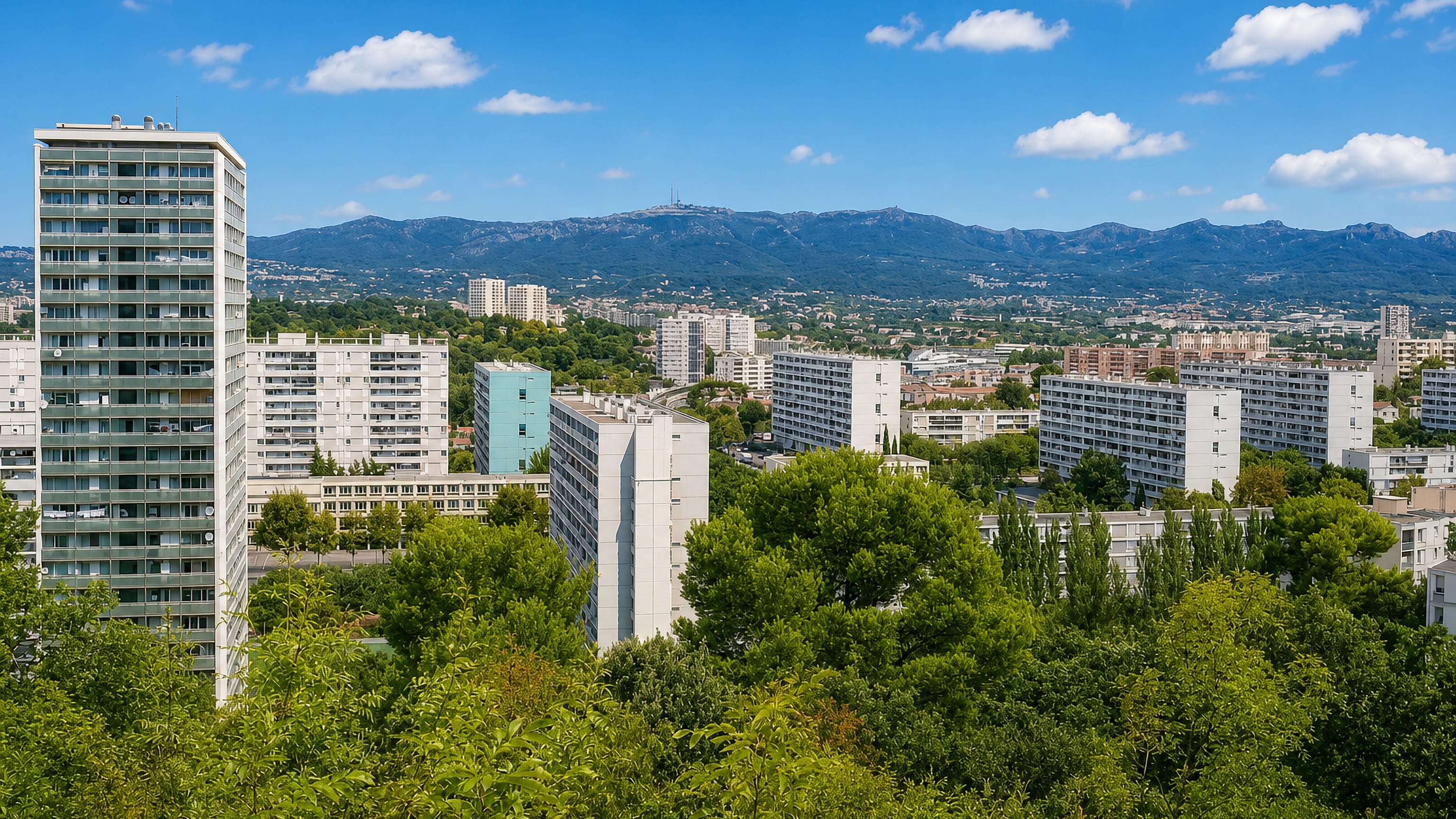 Residential tower blocks in Montolivet, eastern Marseille, framed by the Etoile massif under a blue sky.