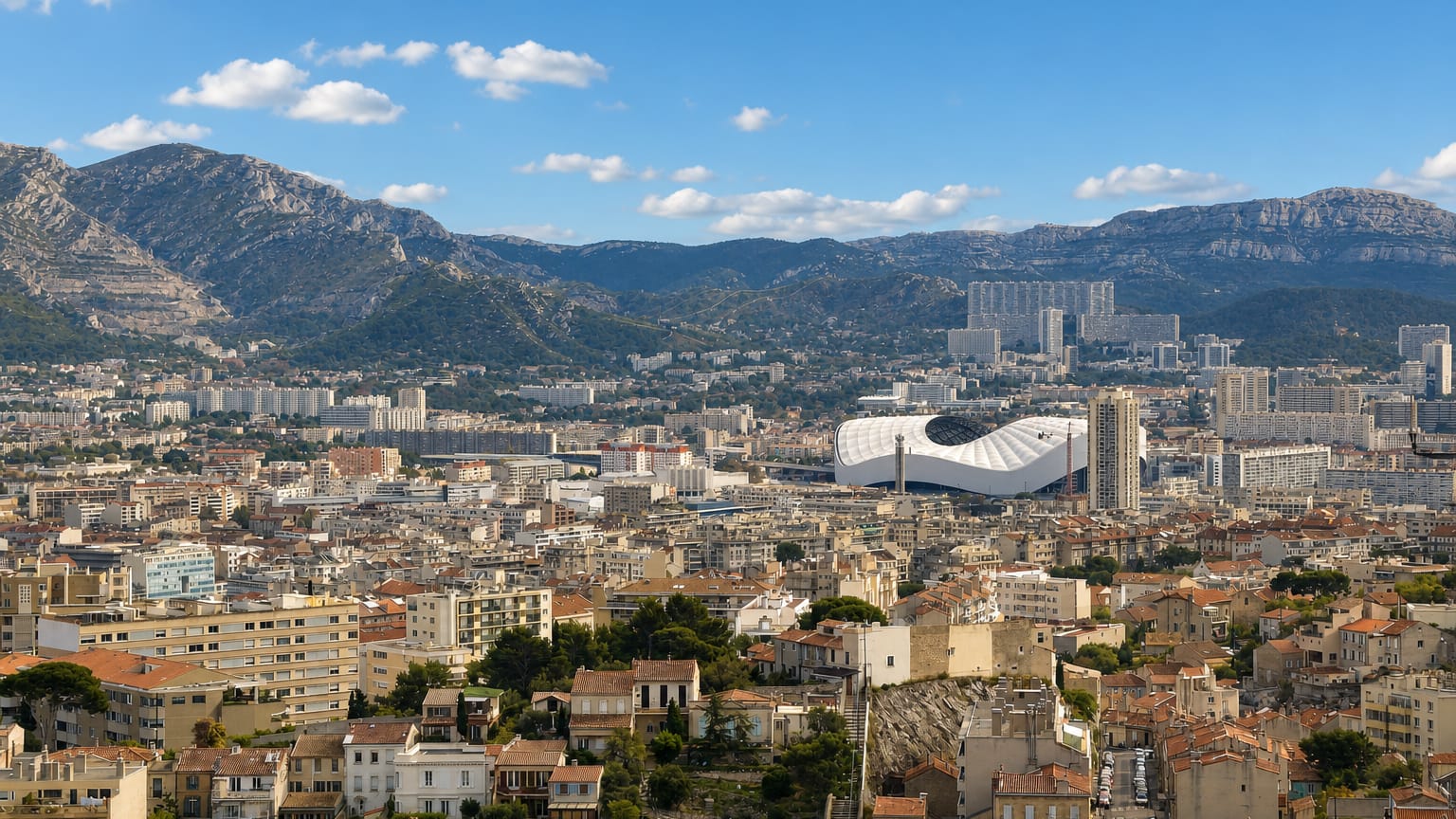 Panorama of Saint-Giniez, Marseille, with the Stade Velodrome and limestone hills behind the rooftops.