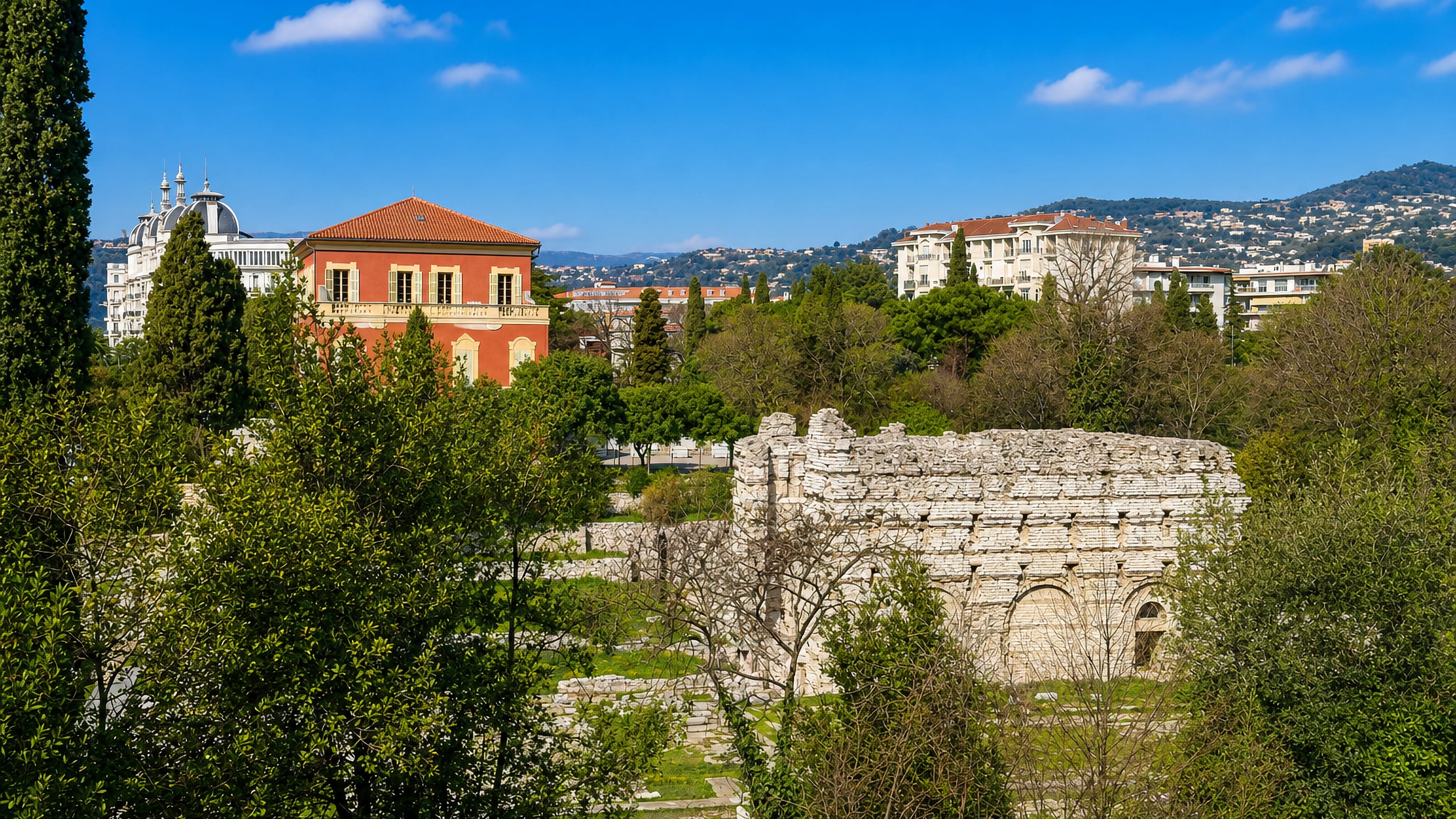 Roman baths ruins in Cimiez, Nice, with the ochre Matisse Museum villa and Regina above.