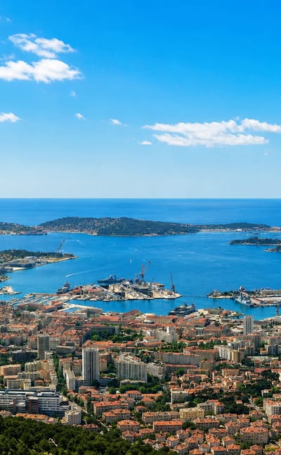 Aerial view of Toulon's natural harbour, naval port and Mediterranean bay ringed by hills, southern France.