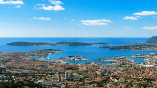 Aerial view of Toulon's natural harbour, naval port and Mediterranean bay ringed by hills, southern France.