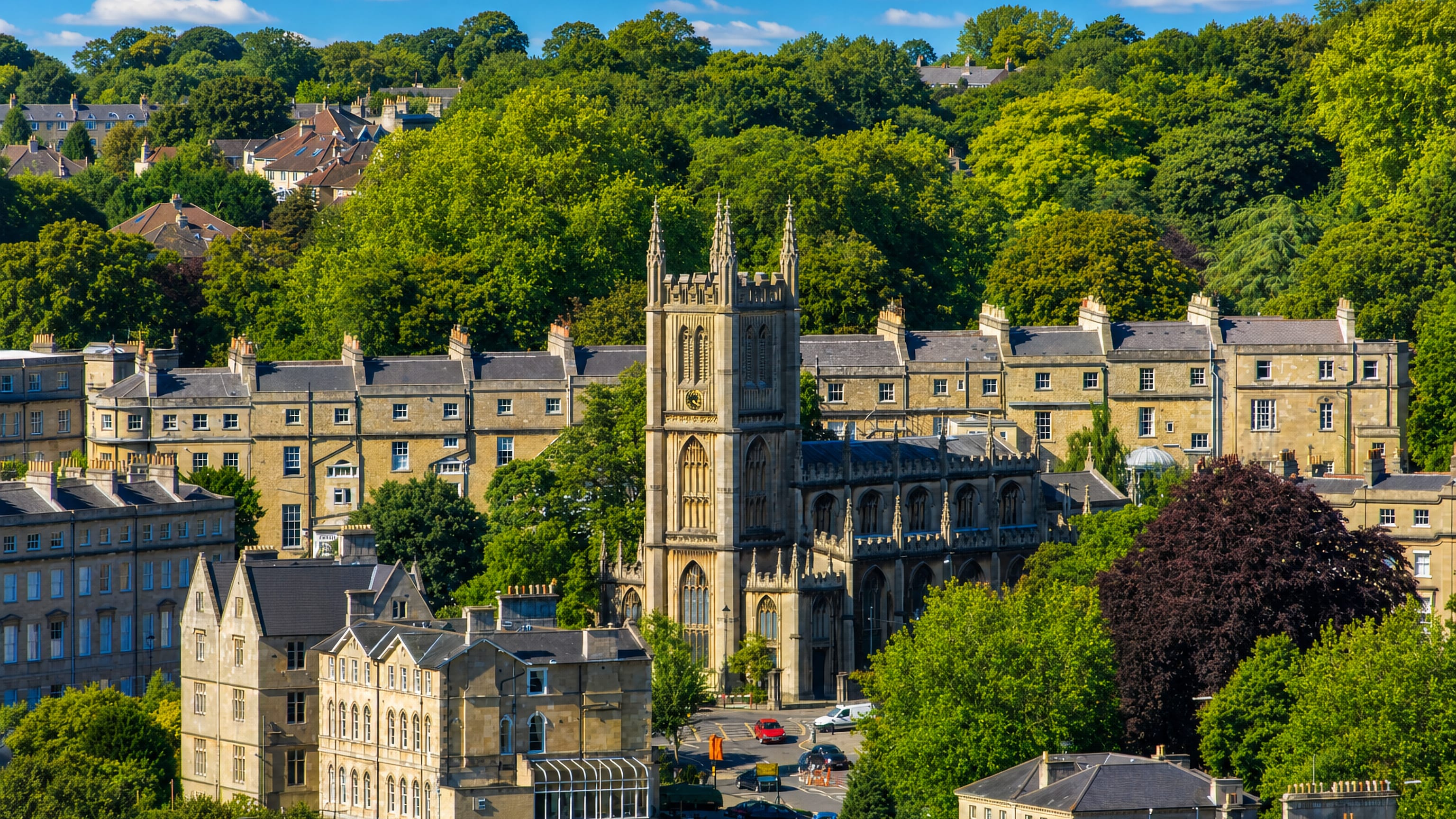Bath stone terraces and the pinnacled church tower on wooded Bathwick Hill, Bath.