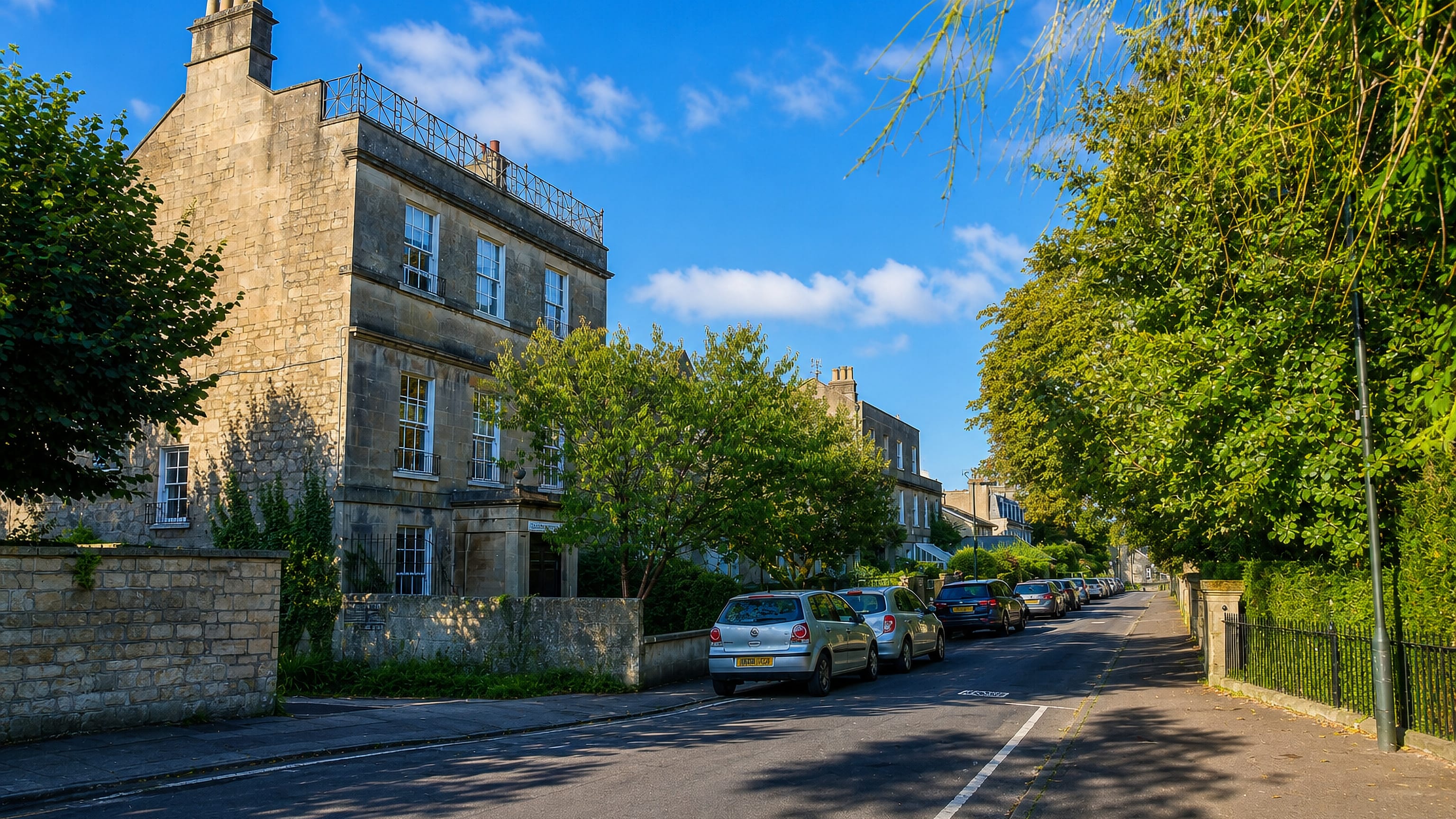 Bath stone Georgian villa and tree-lined lane climbing through Combe Down on the southern hills of Bath