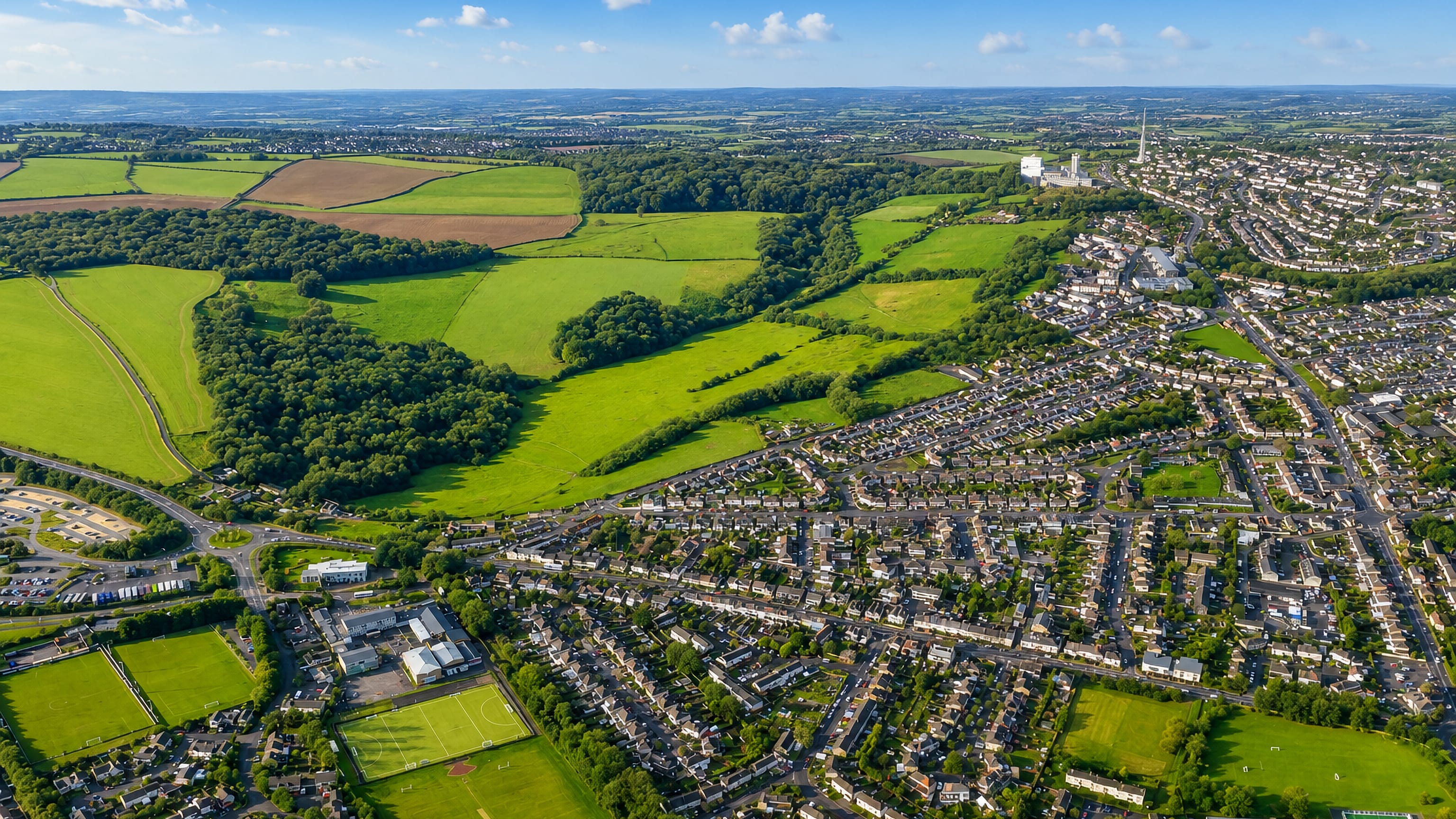 Aerial view of Odd Down, Bath, where suburban housing and playing fields meet open farmland.