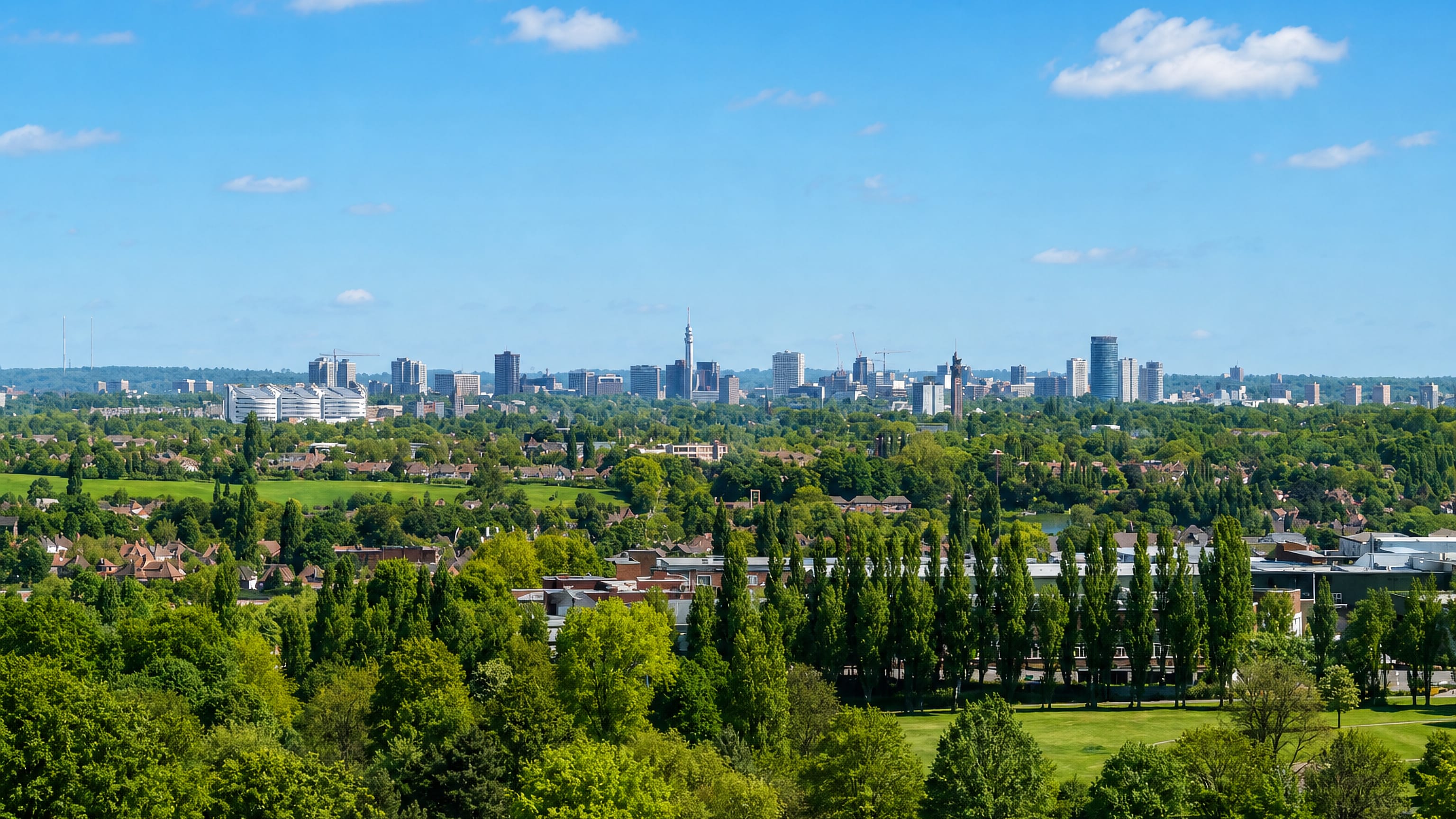 Birmingham's city-centre skyline seen across the wooded suburbs and parkland of Longbridge