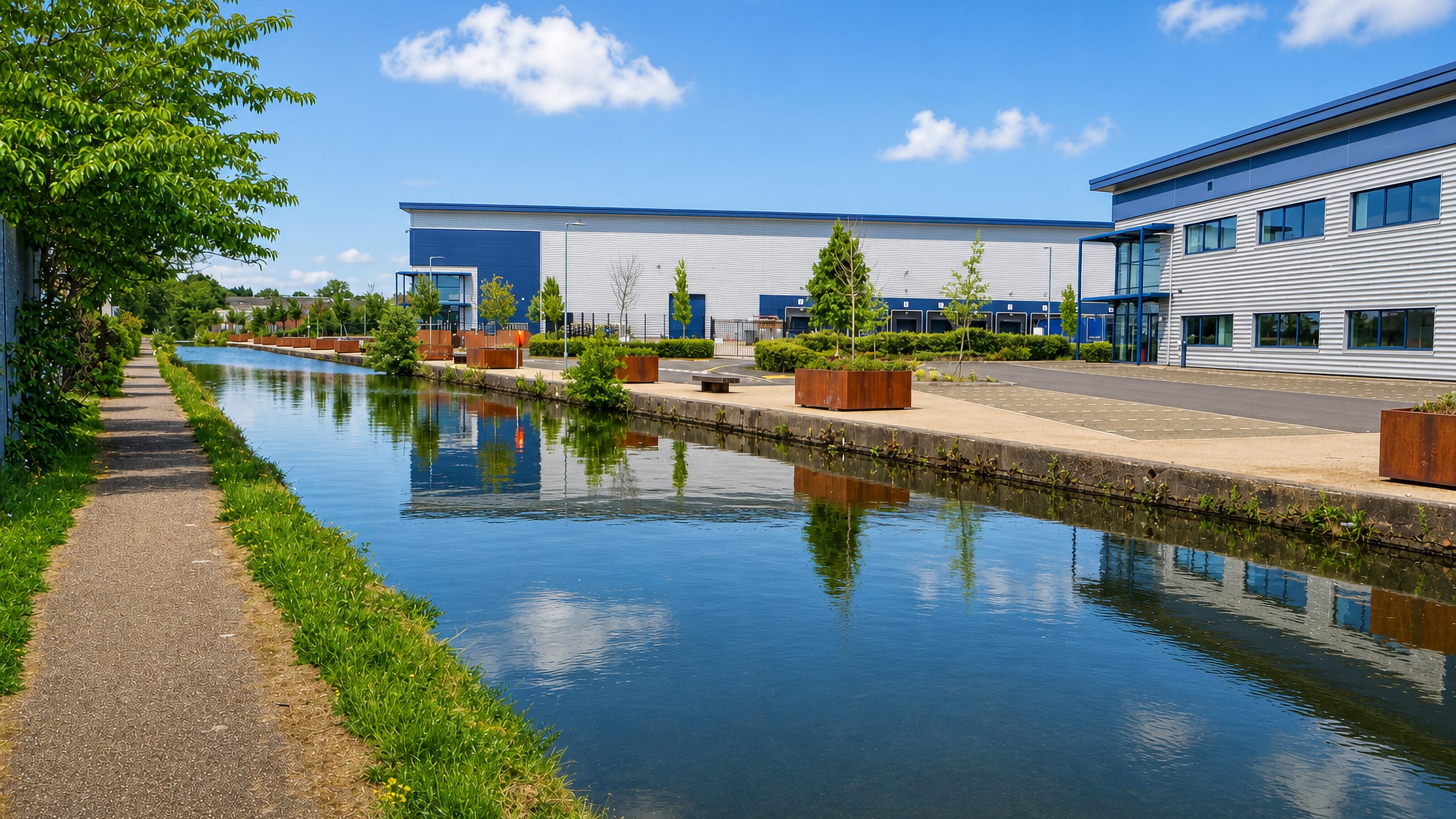 Grand Union Canal towpath past modern warehouse and office units in Tyseley, Birmingham