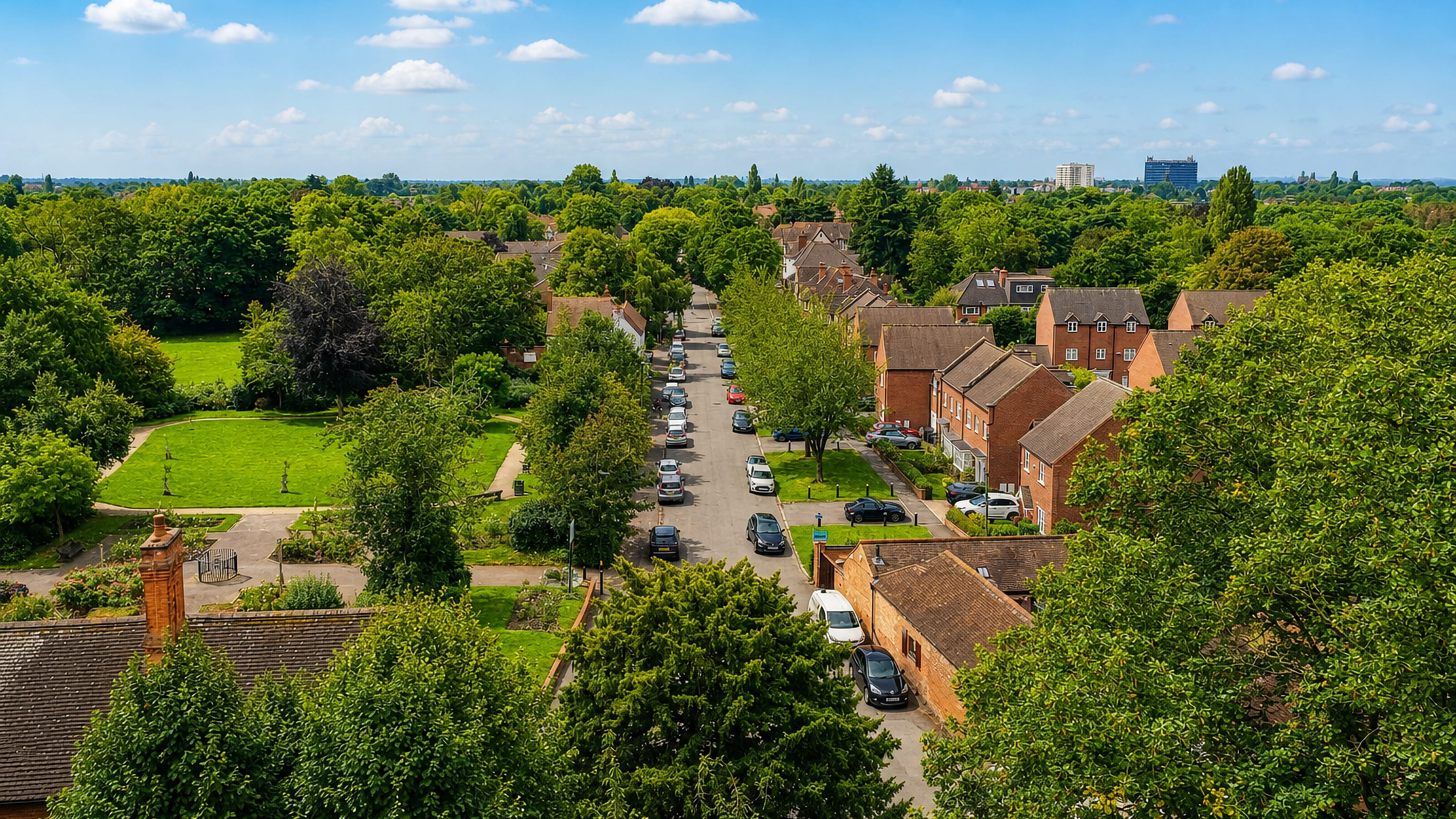 Aerial view of Yardley, Birmingham, showing a tree-lined residential street, brick houses and a green park.