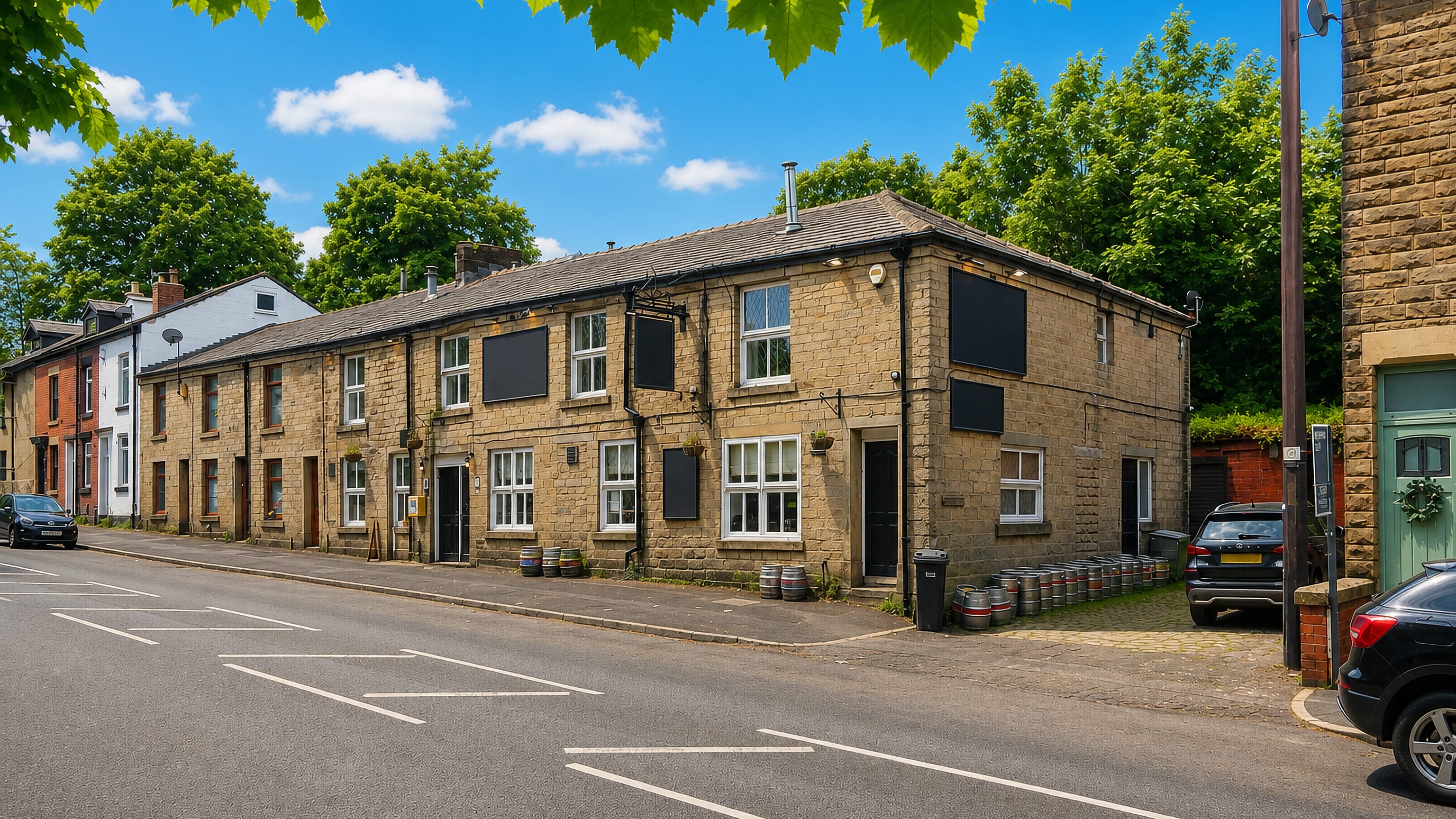 Stone-built terrace and village pub with beer kegs outside on a quiet road in Eagley, Bolton.