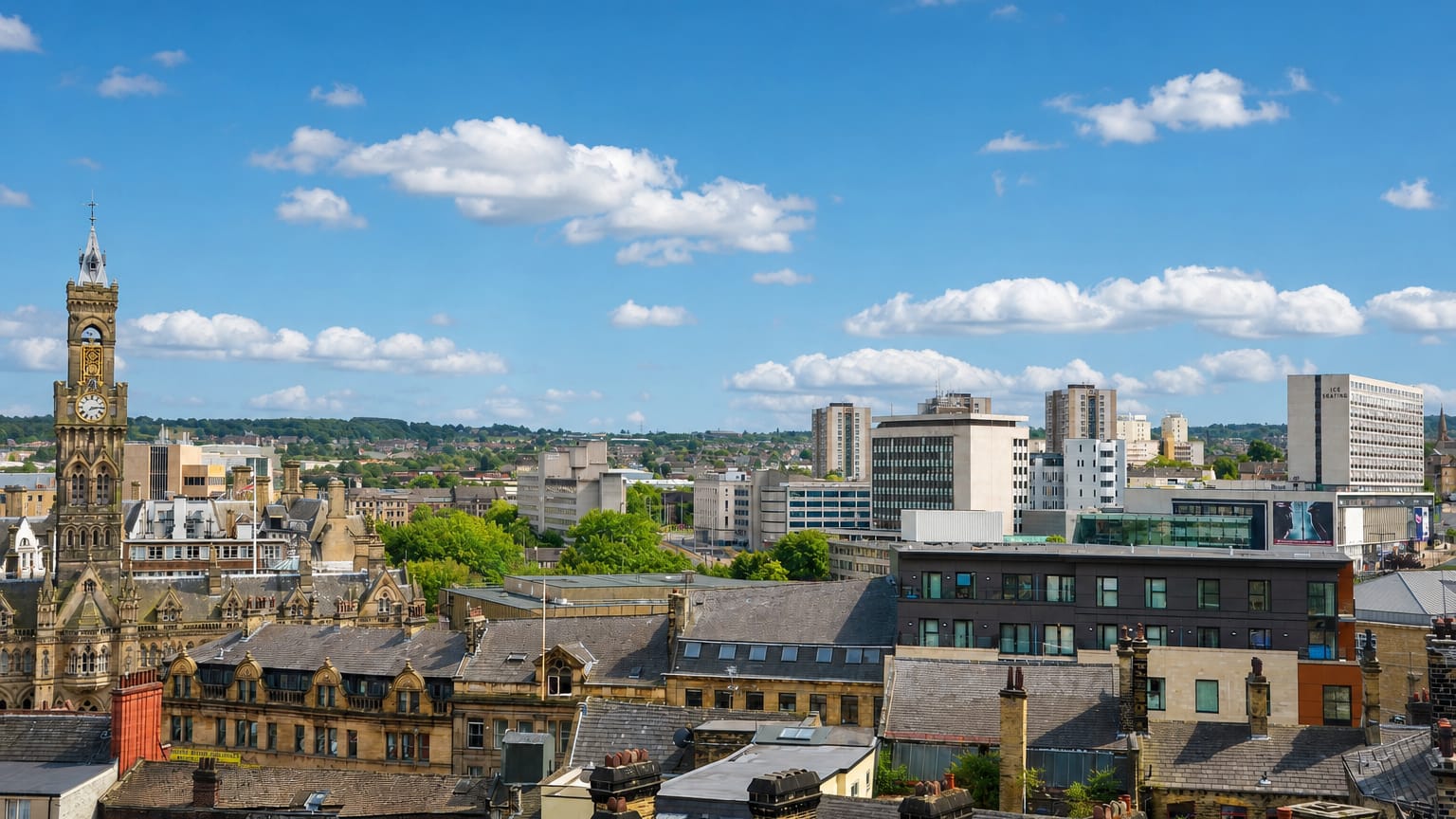 Bradford skyline with City Hall's Italianate clock tower, Victorian stone buildings and distant tower blocks