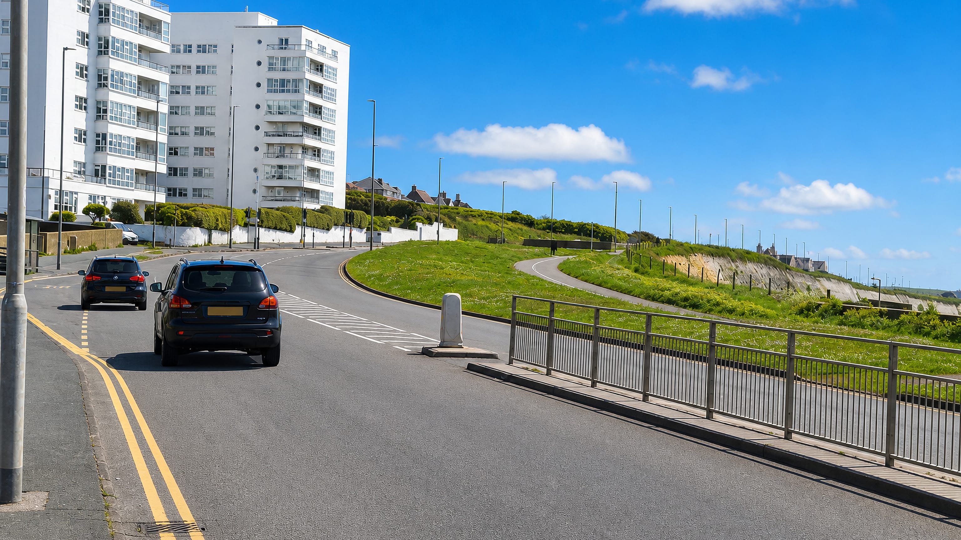 Roedean in Brighton, with a white deco apartment block on the clifftop road above the sea.