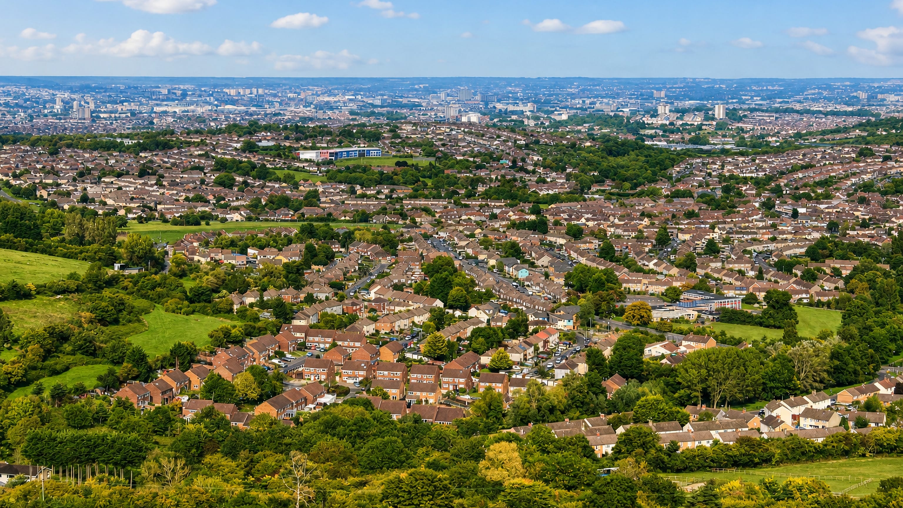 Bishopsworth's rooftops spread below the Dundry hills in south Bristol, with the city skyline on the horizon.
