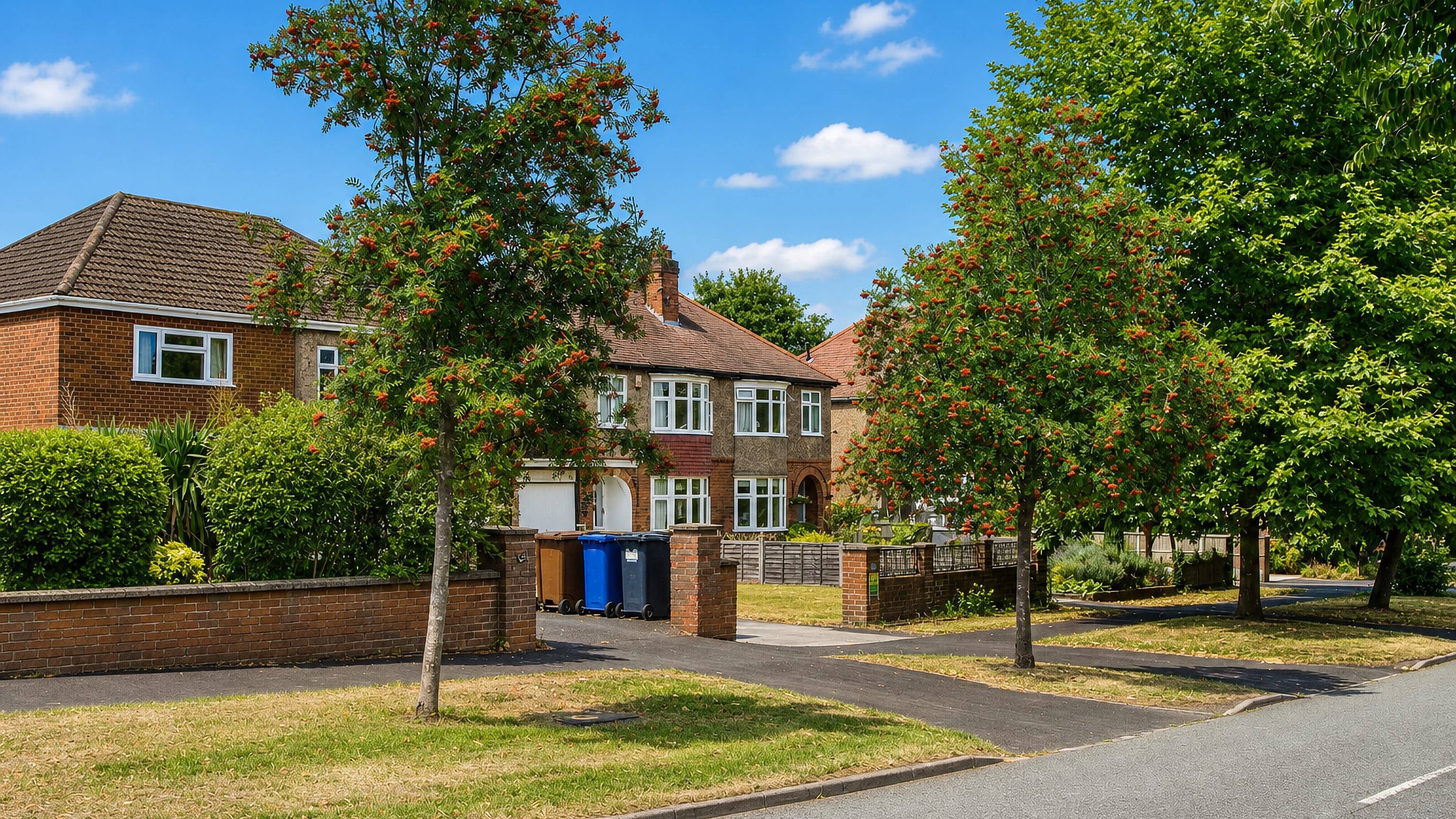 Rowan-lined residential avenue of brick semi-detached houses in Outwoods, Burton upon Trent.
