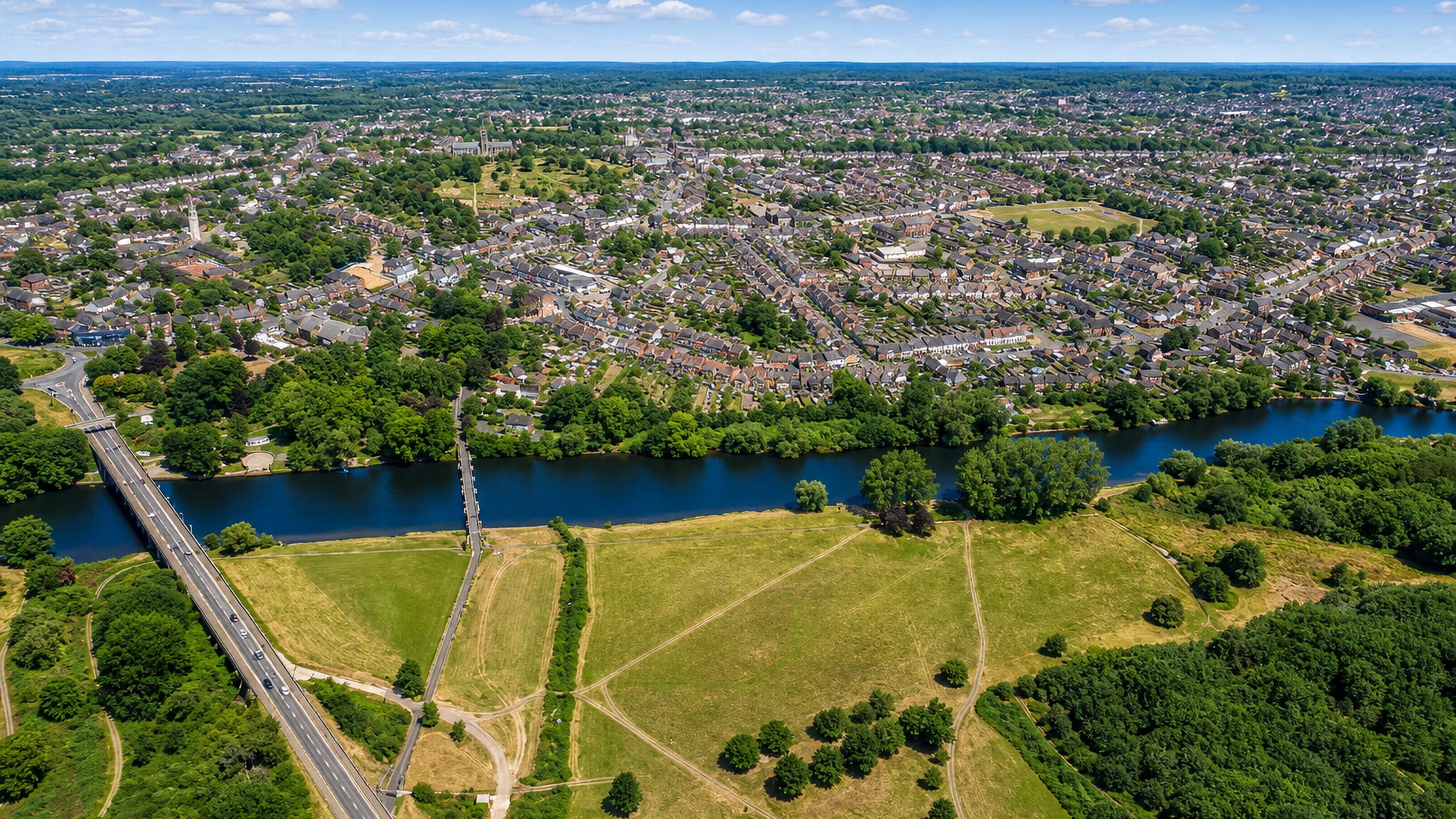Stapenhill across the River Trent from Burton upon Trent, with the Washlands meadows and footbridge.