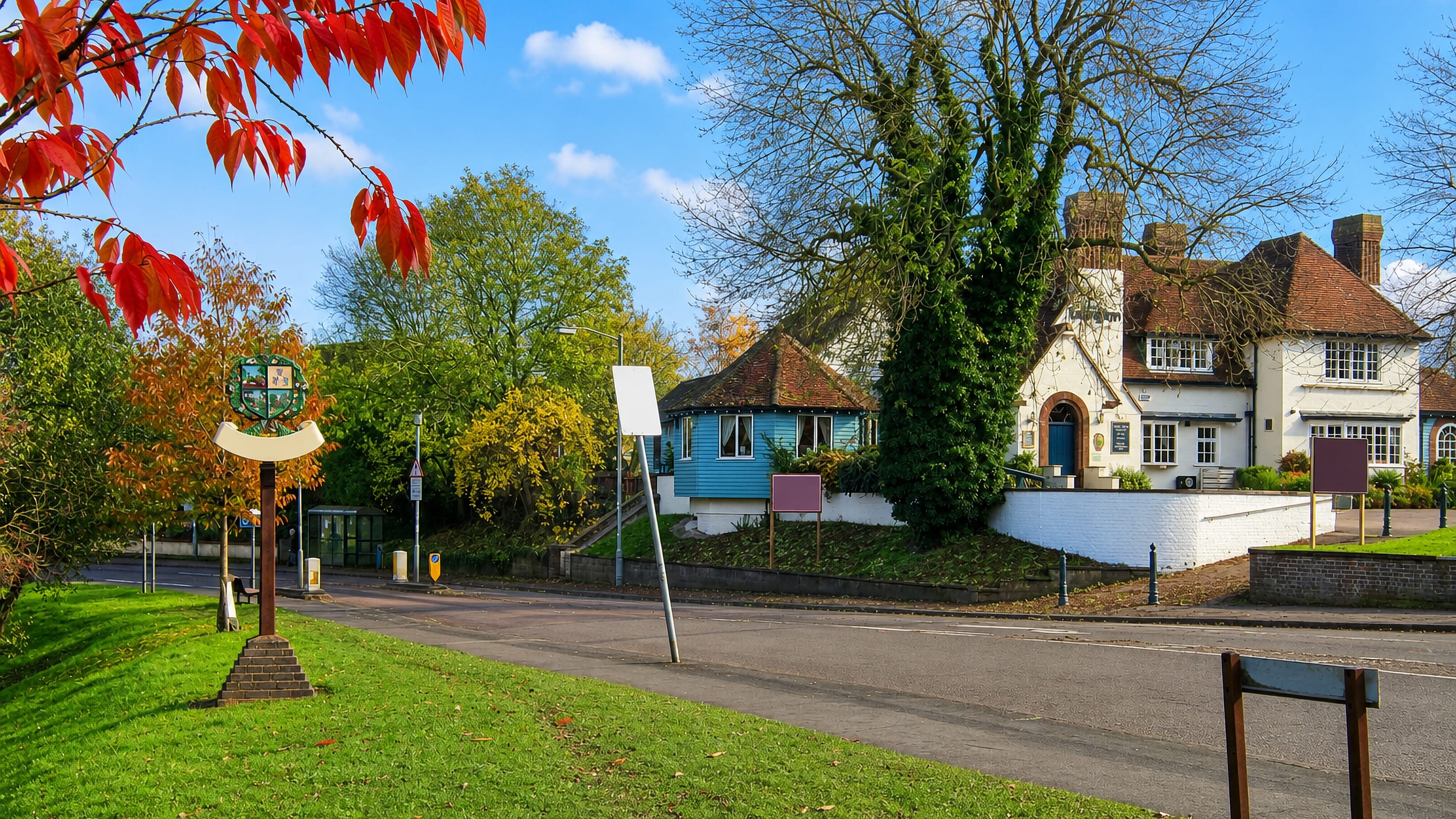 Village sign, green and a white-washed roadside pub in Cherry Hinton on the edge of Cambridge.