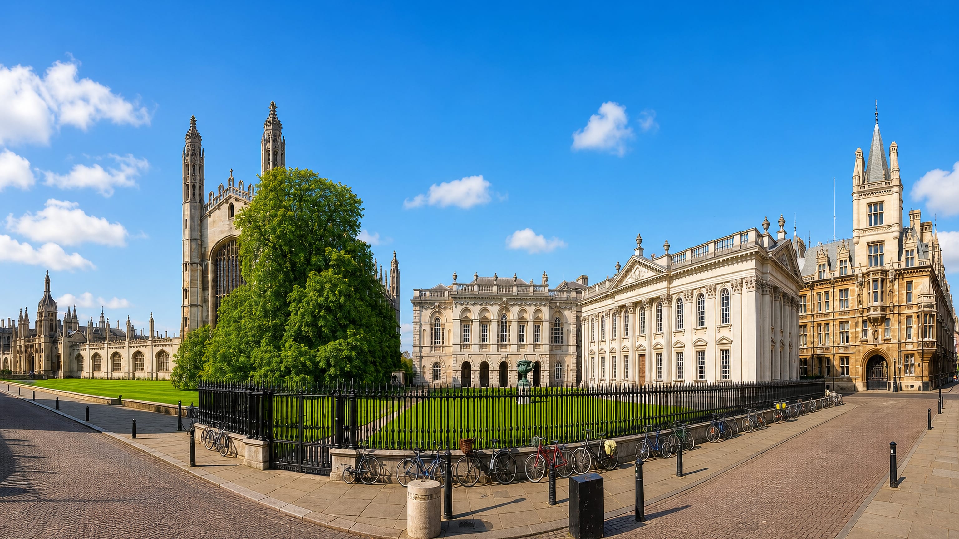 King's College Chapel and the neoclassical Senate House in central Cambridge, England, under a clear blue sky.