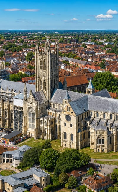 Aerial view of Canterbury Cathedral and its Bell Harry tower amid the medieval town's red-roofed streets