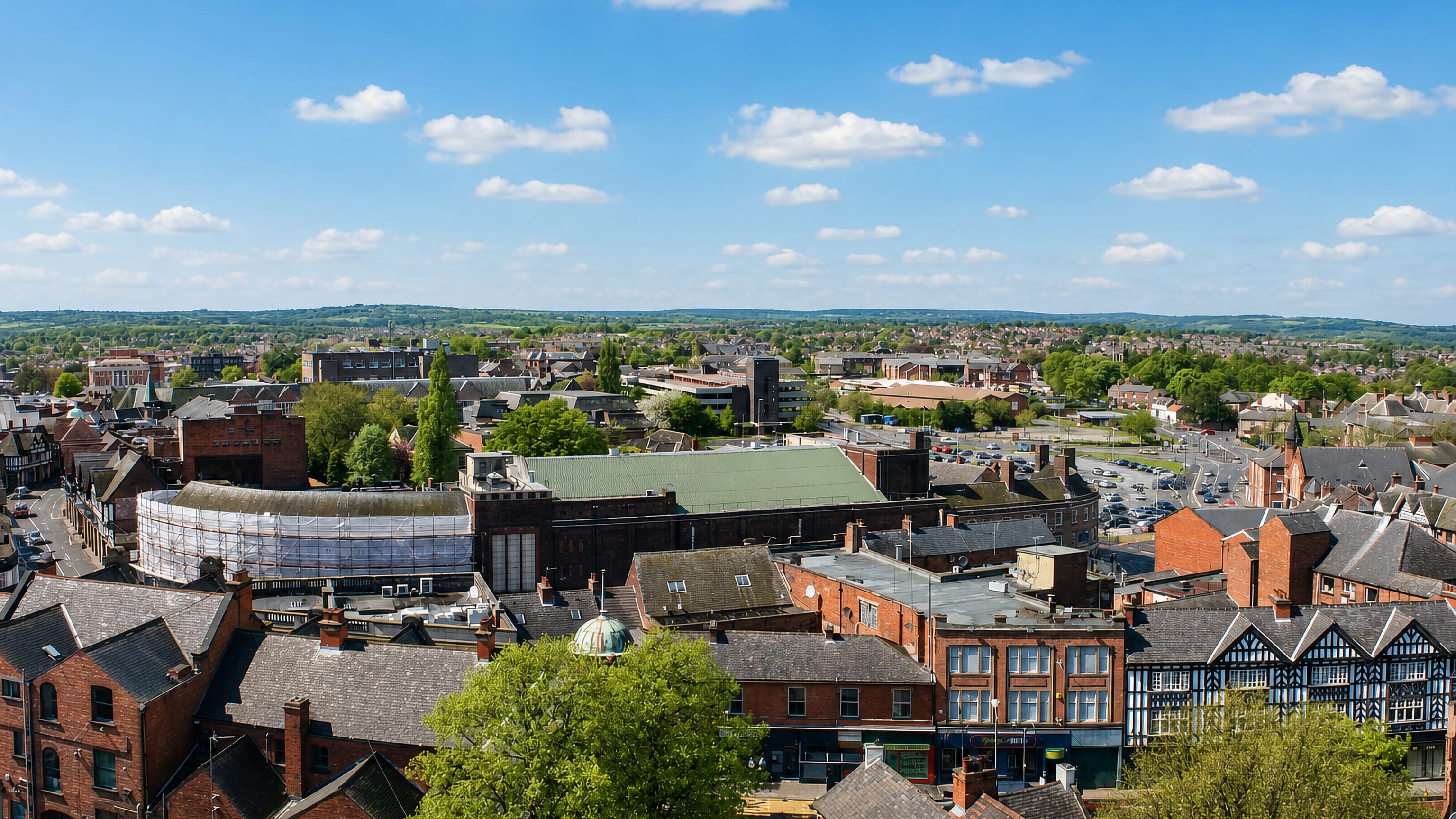 Rooftops of Chesterfield's town centre and market hall with the Derbyshire hills beyond, England.