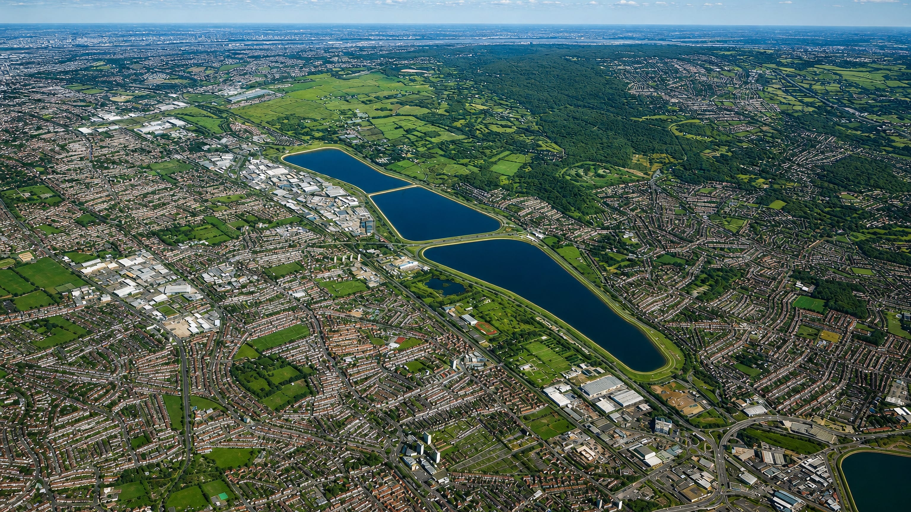 Aerial view of Chingford, north-east London, with the Lea Valley reservoirs and Epping Forest greenery.