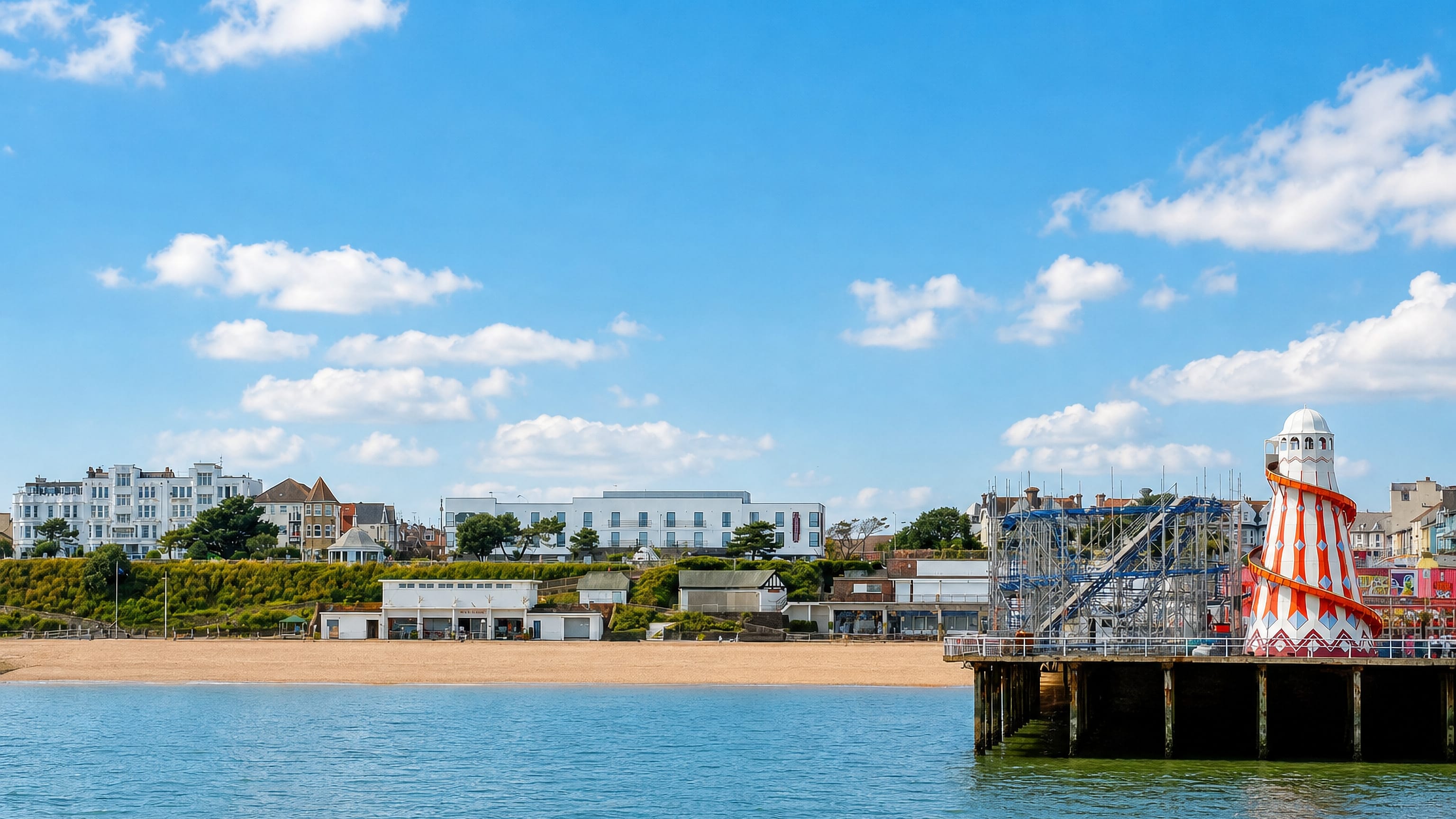Clacton-on-Sea's sandy beach and pier helter-skelter with the Essex seafront terraces beyond.