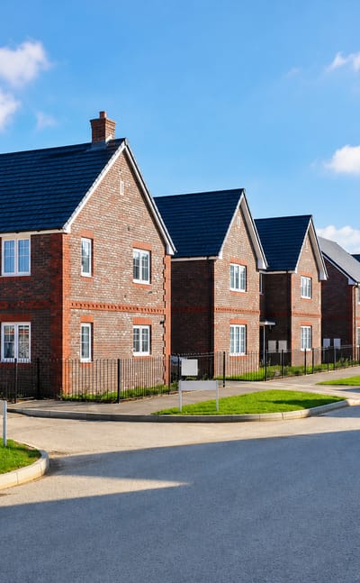 Newly built red-brick houses along a wide street on the Forge Wood estate, Crawley