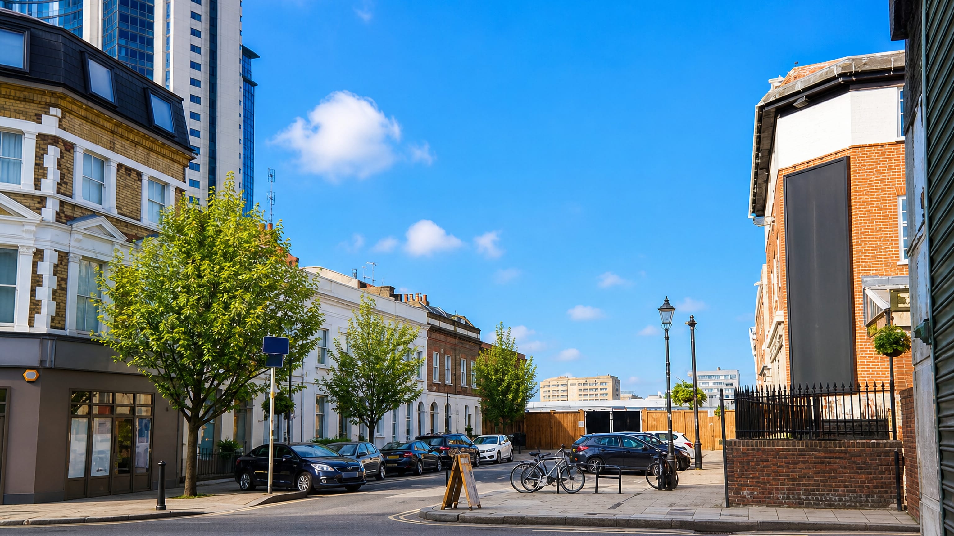 Brick terraced houses and a modern glass tower on a quiet residential street in Fulham, west London