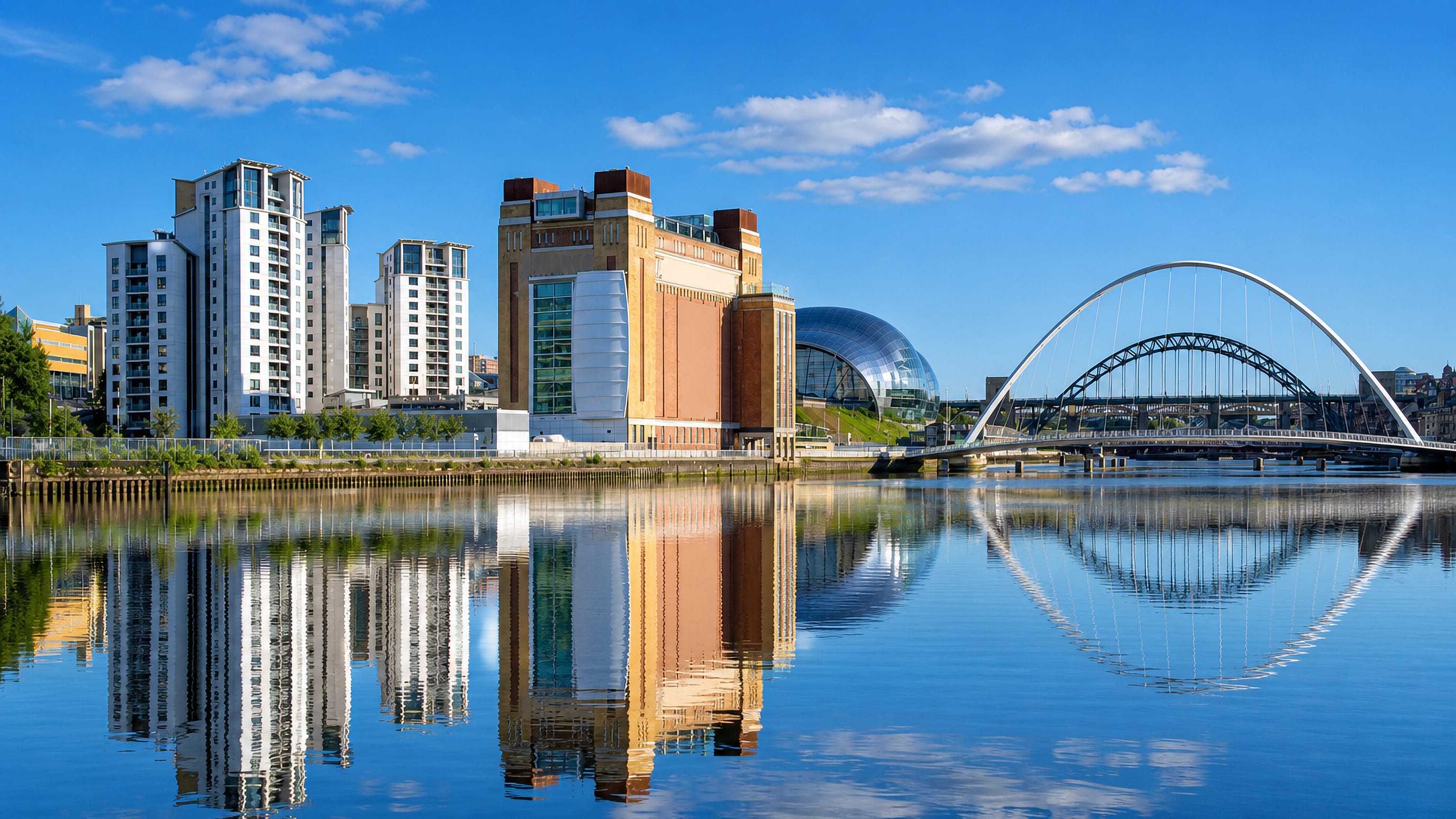 Gateshead Quays on the Tyne, with the BALTIC mill, Sage concert hall and Millennium Bridge mirrored in the water.