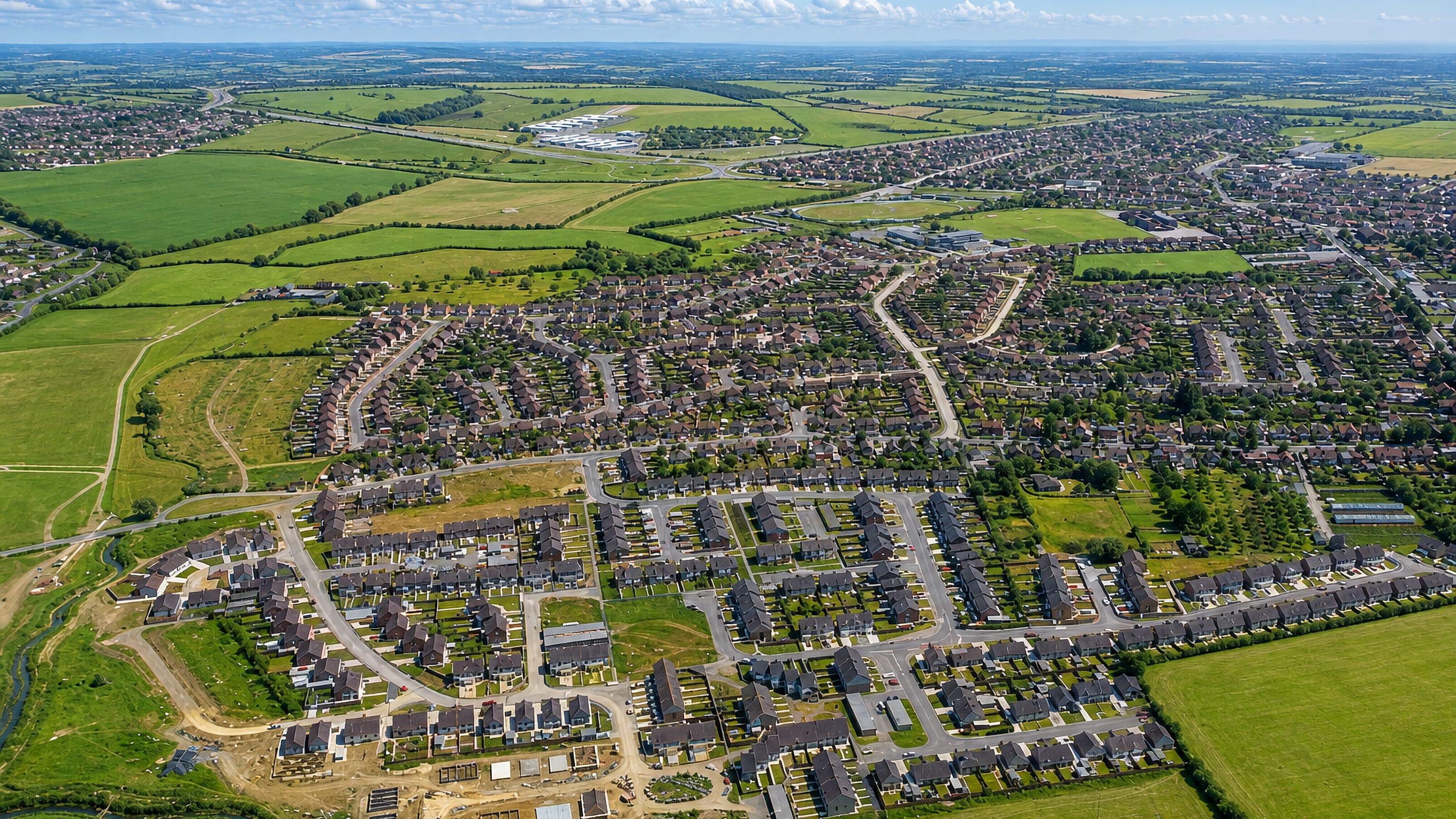 Aerial view over the housing estates and surrounding farmland of Longlevens on the edge of Gloucester.