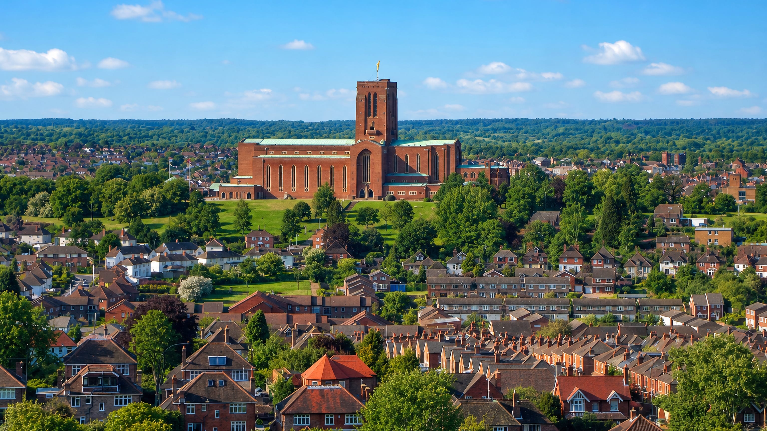 Guildford Cathedral on Stag Hill rising above the town's brick rooftops and the wooded Surrey hills