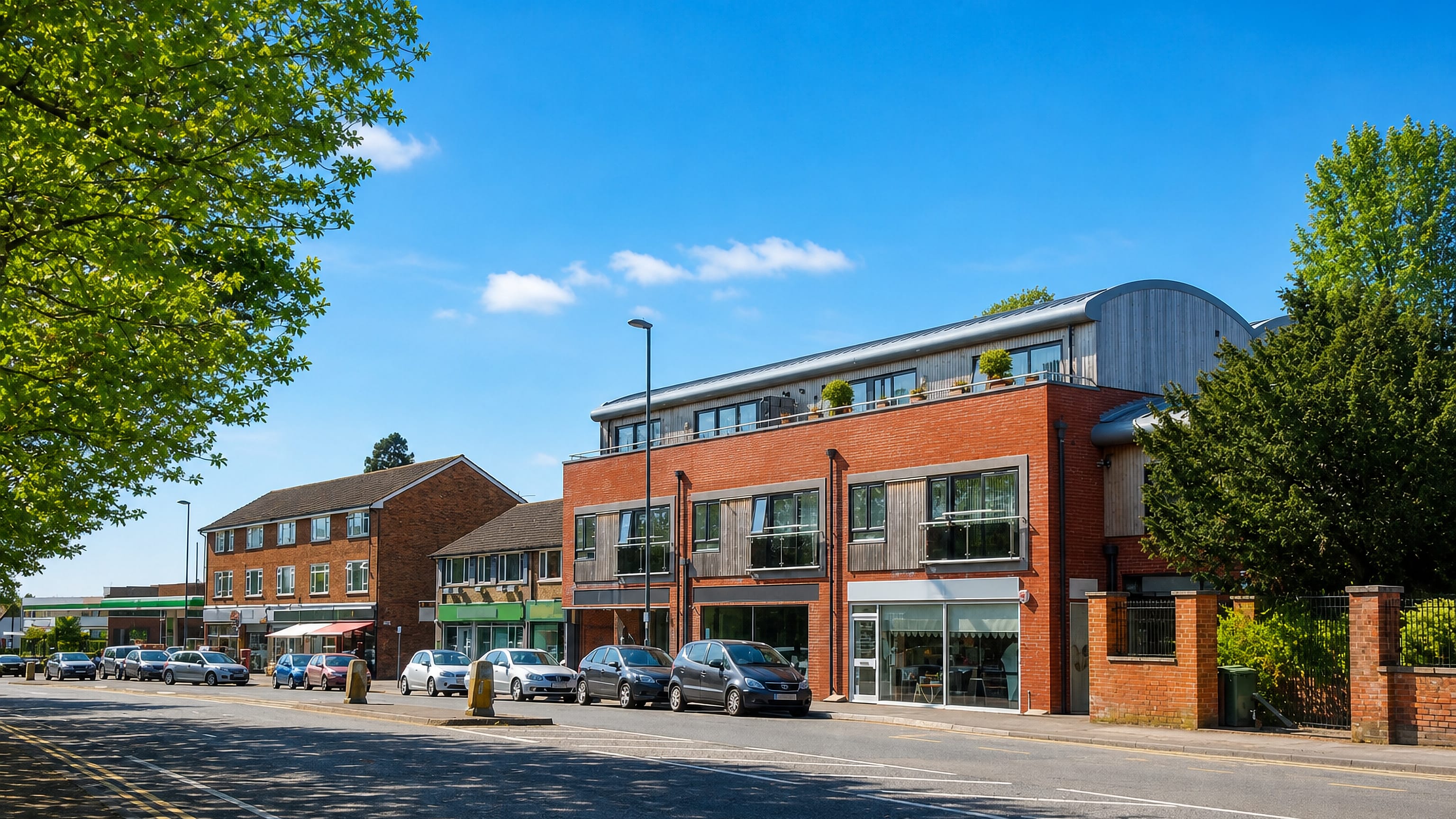 Red-brick shops and flats lining the main road through Merrow on the eastern edge of Guildford.