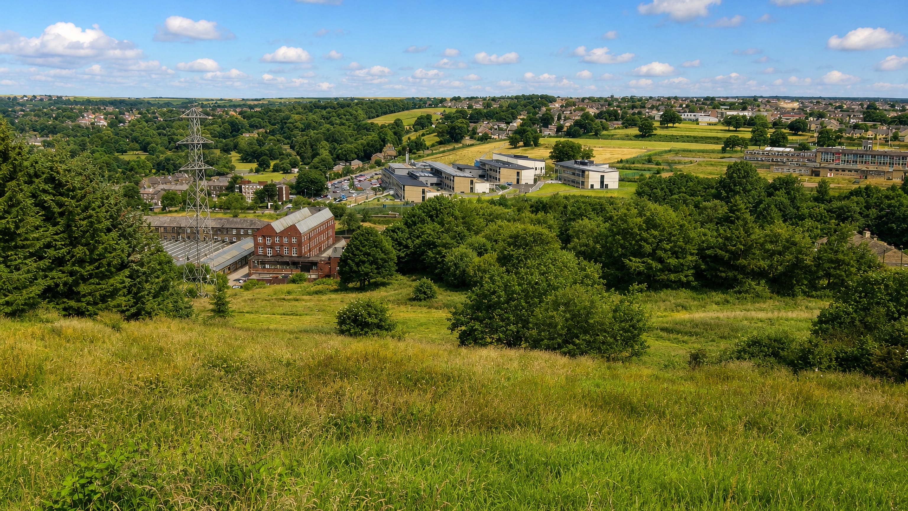 Holdsworth's mill, school and stone housing spread across the Pennine valley north of Halifax.