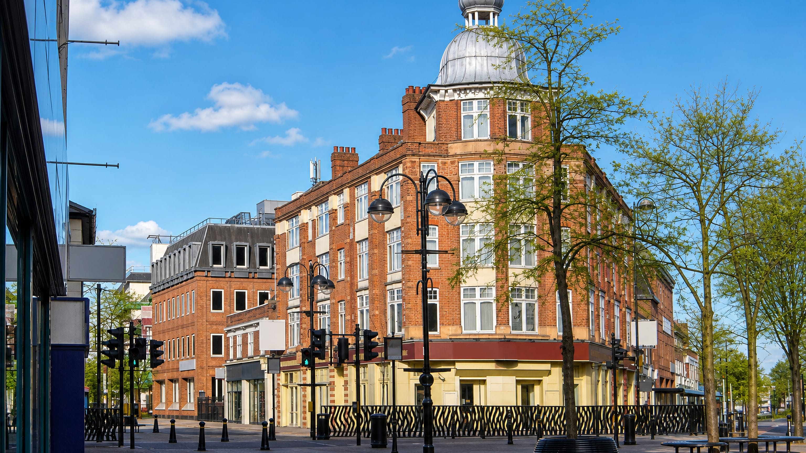 Domed red-brick Edwardian corner building on Hounslow's pedestrianised high street in west London.