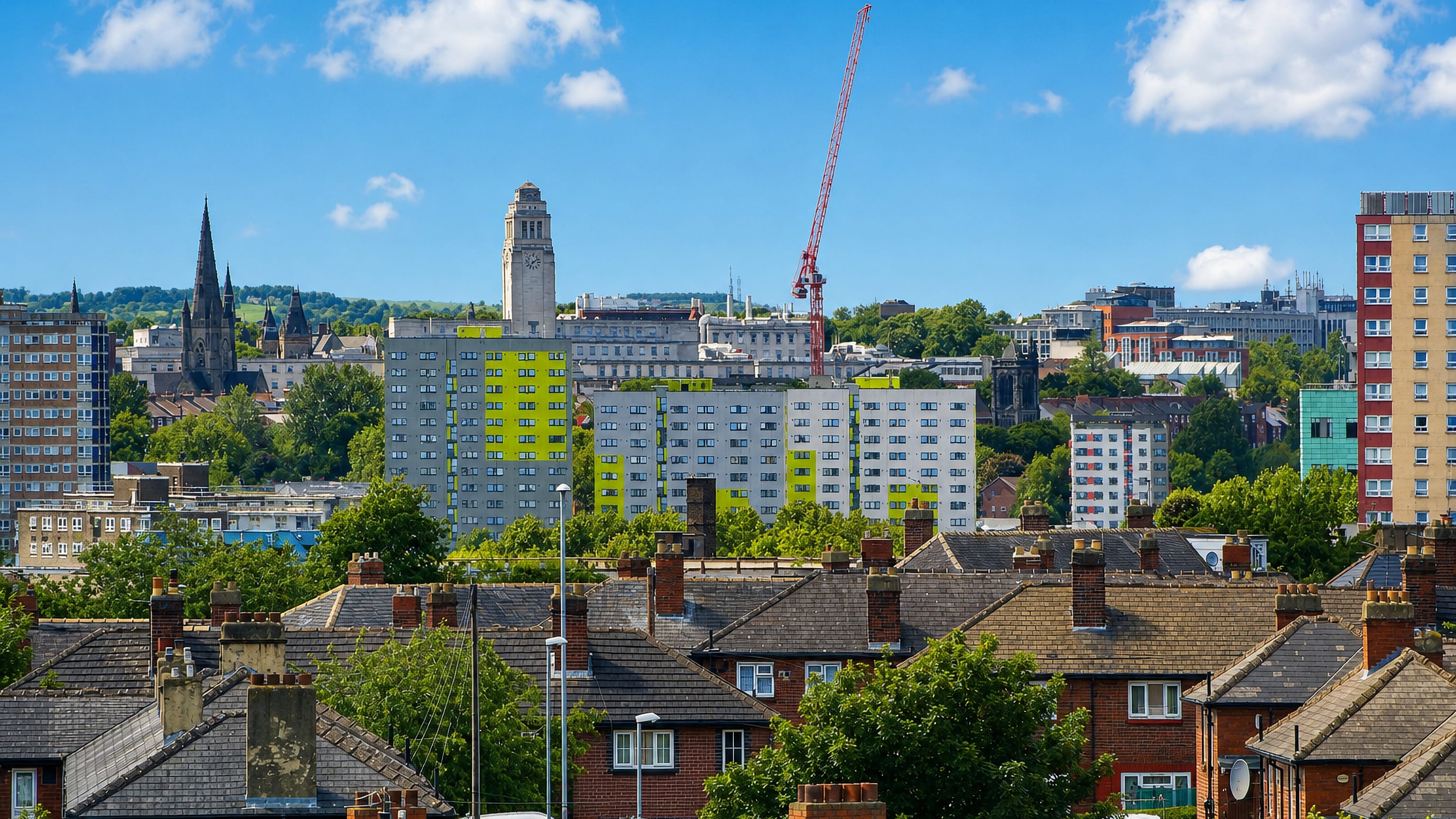 Terraced rooftops in Osmondthorpe frame the Leeds skyline, its white university clock tower and tower blocks.