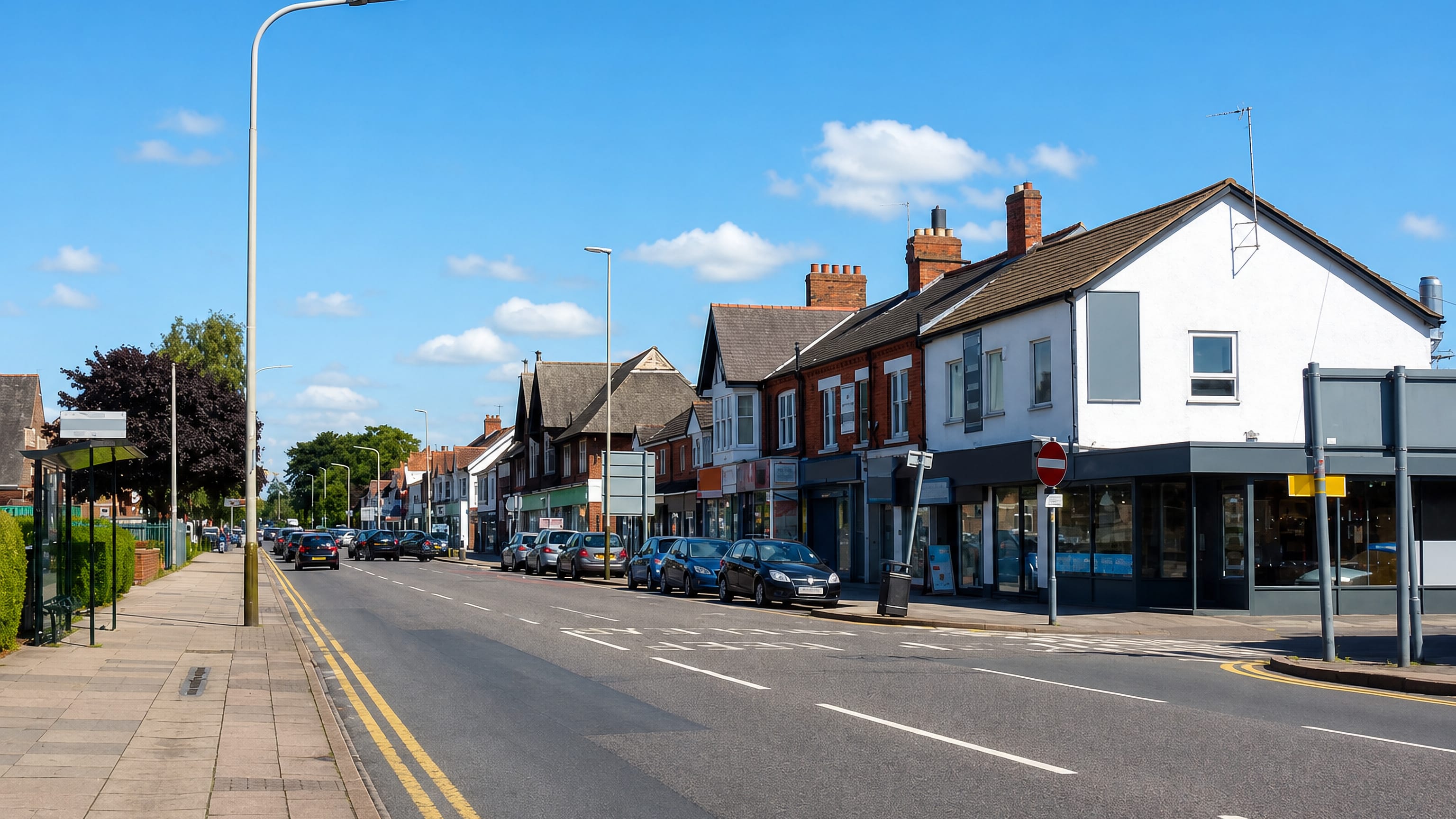 Shops and Victorian brick terraces along the main road through Spinney Hills, Leicester.