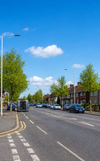 Tree-lined residential street of interwar semi-detached houses on the Becontree estate, London.