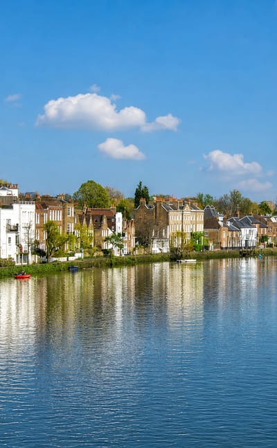 Thames-side terraced houses reflected in the river at Chiswick, west London