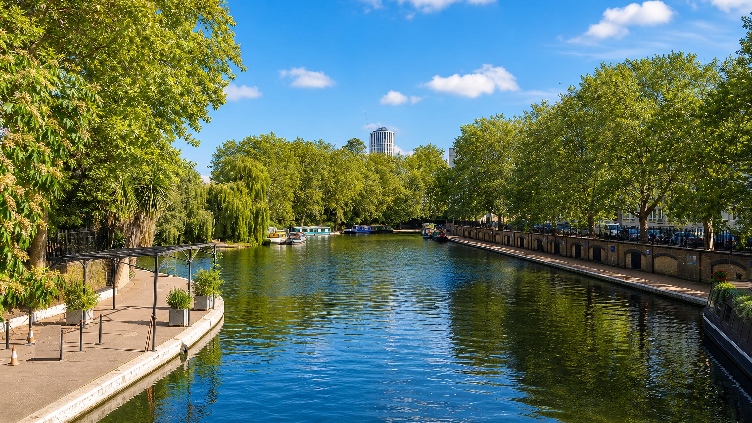 Narrowboats moored along the tree-lined canal basin at Little Venice in west London