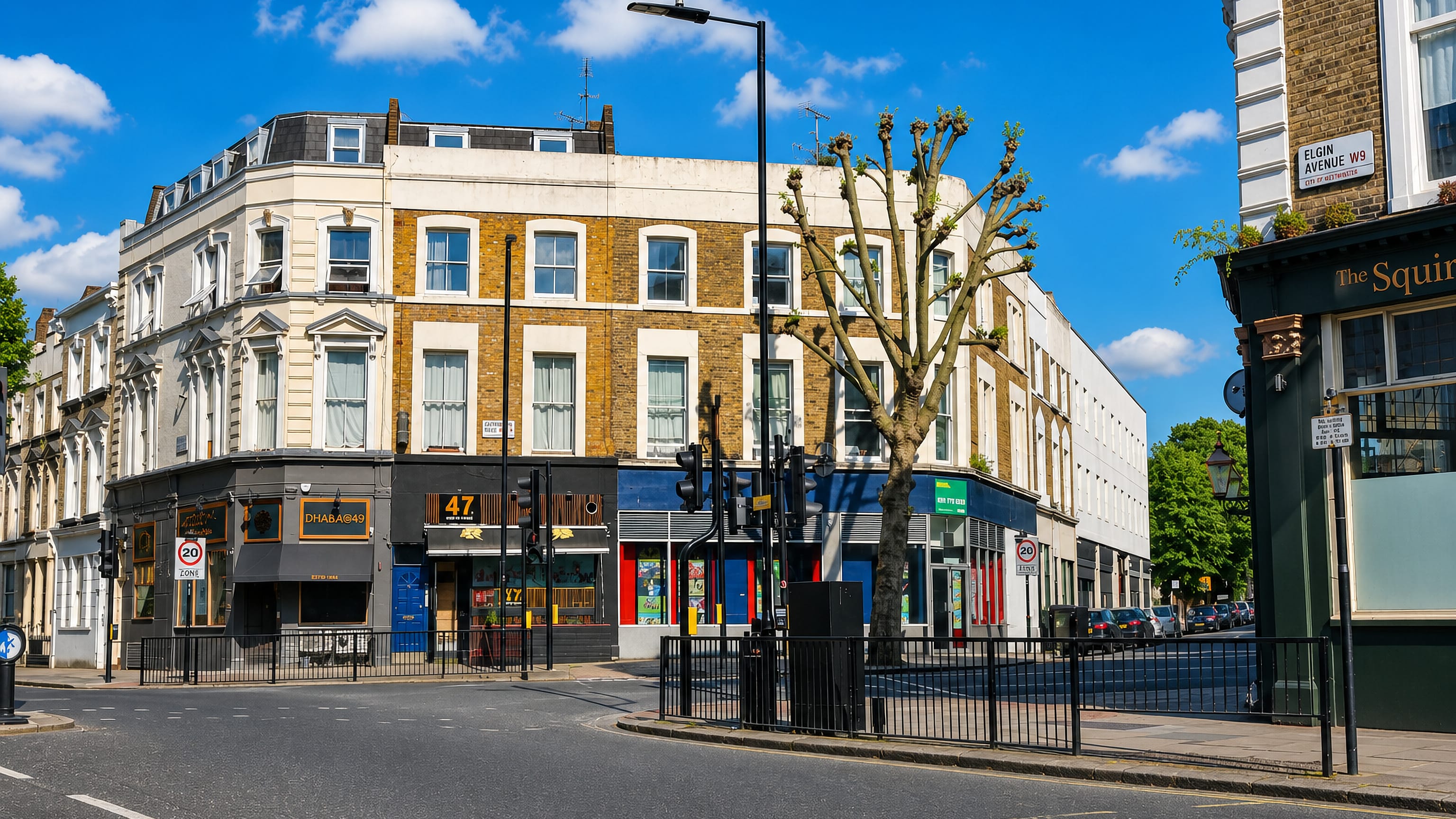 A quiet Maida Hill street corner in London with a pub and parade of shops beside the Elgin Avenue W9 sign