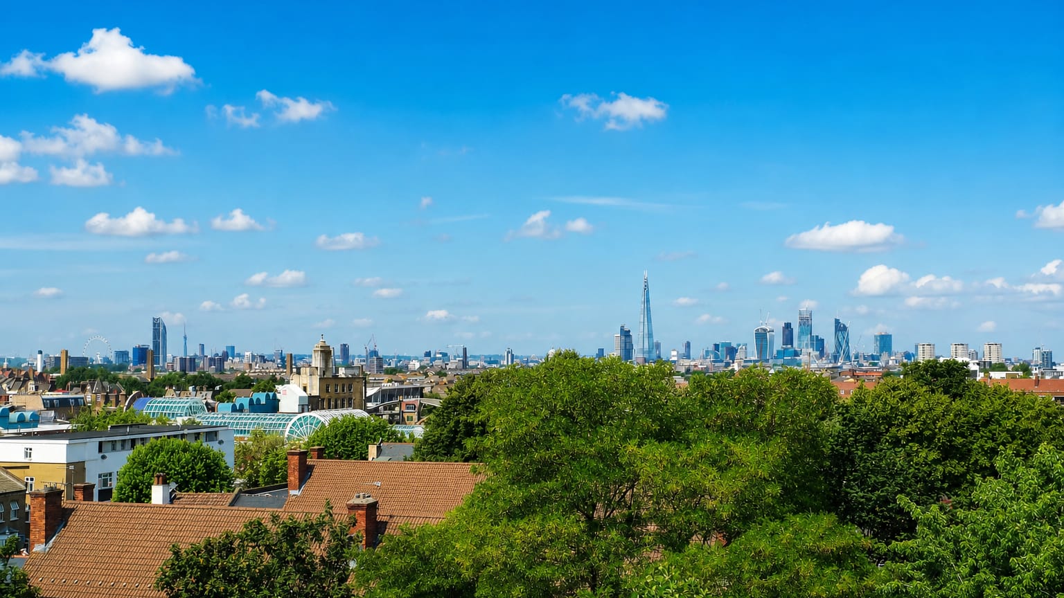 View across Peckham rooftops to the distant central London skyline with the Shard on a clear day.