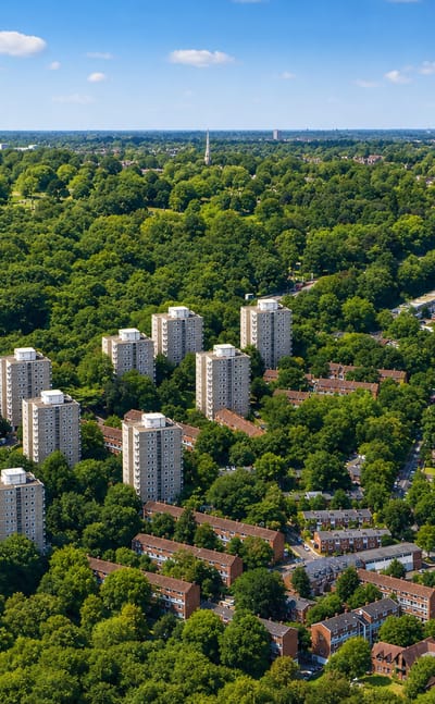 Aerial of Roehampton's Alton Estate tower blocks amid greenery beside Richmond Park.