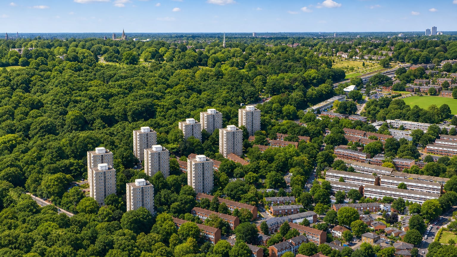 Aerial of Roehampton's Alton Estate tower blocks amid greenery beside Richmond Park.