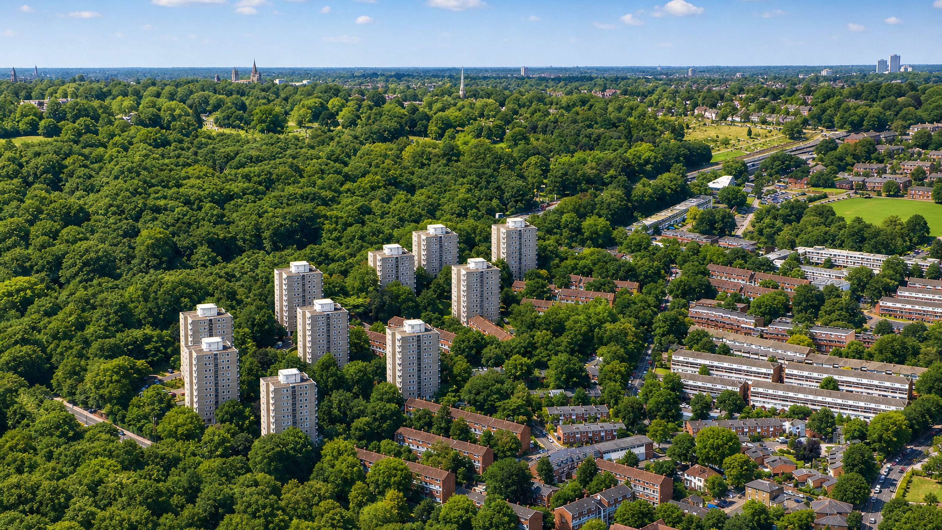 Aerial of Roehampton's Alton Estate tower blocks amid greenery beside Richmond Park.