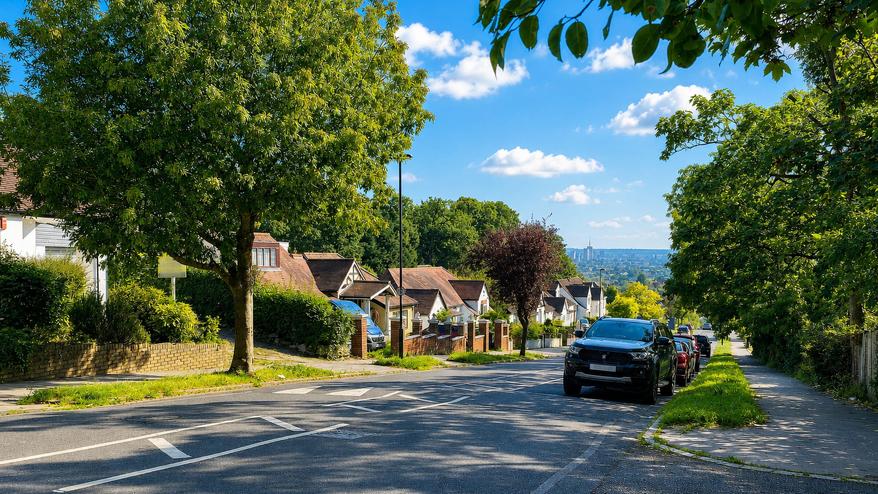 A leafy hillside street of houses in Upper Norwood, south London, looking out over the distant city skyline.