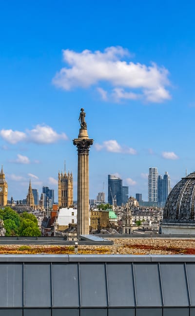 Rooftop view across London's West End with Nelson's Column, Big Ben and the City skyline beyond Trafalgar Square