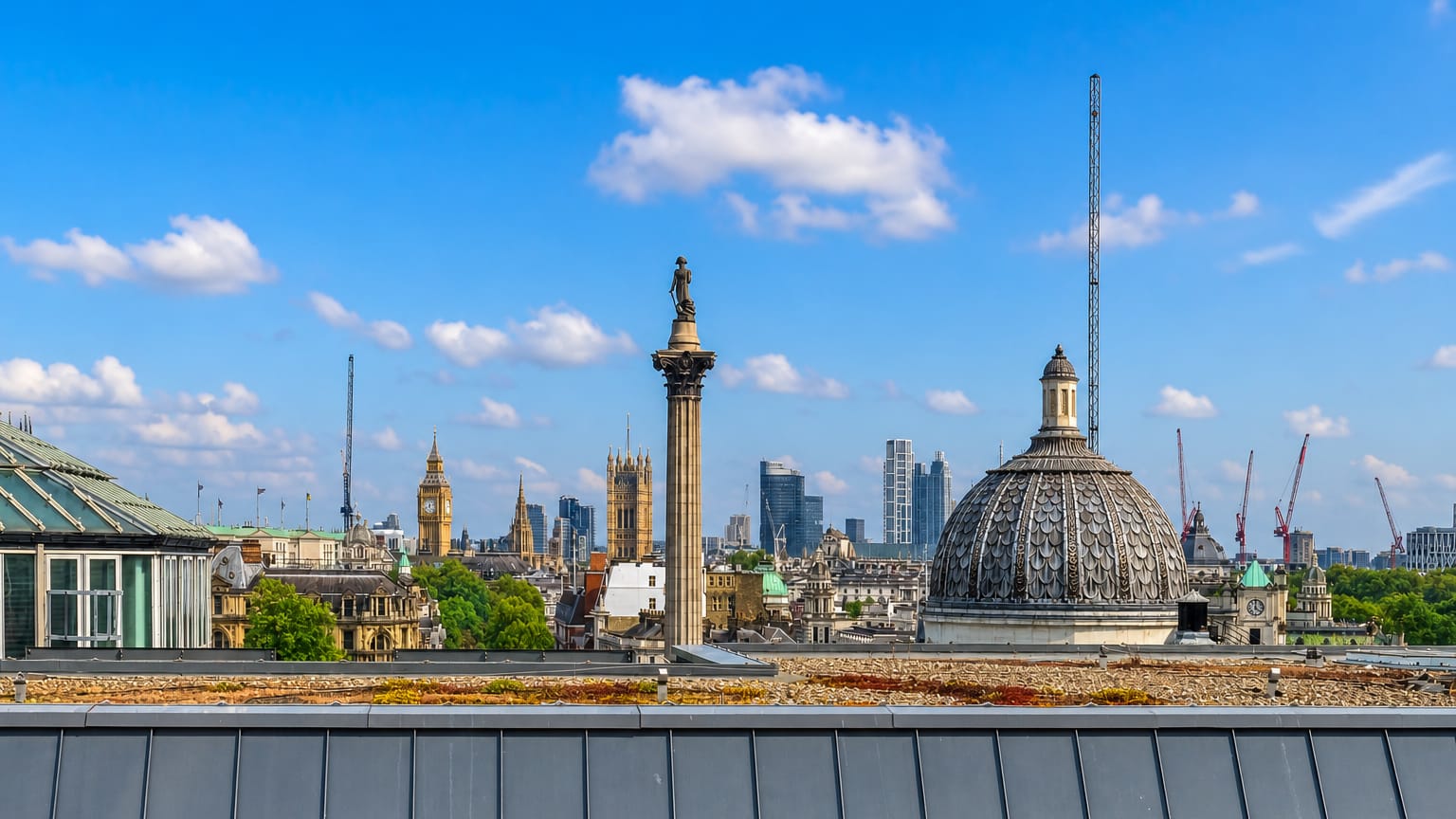 Rooftop view across London's West End with Nelson's Column, Big Ben and the City skyline beyond Trafalgar Square