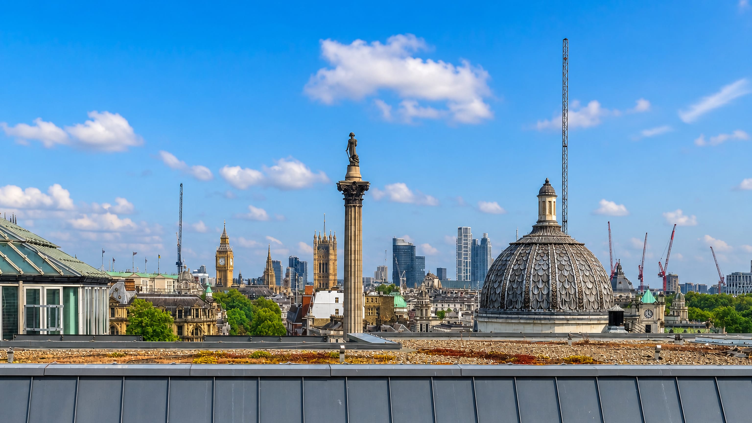 Rooftop view across London's West End with Nelson's Column, Big Ben and the City skyline beyond Trafalgar Square