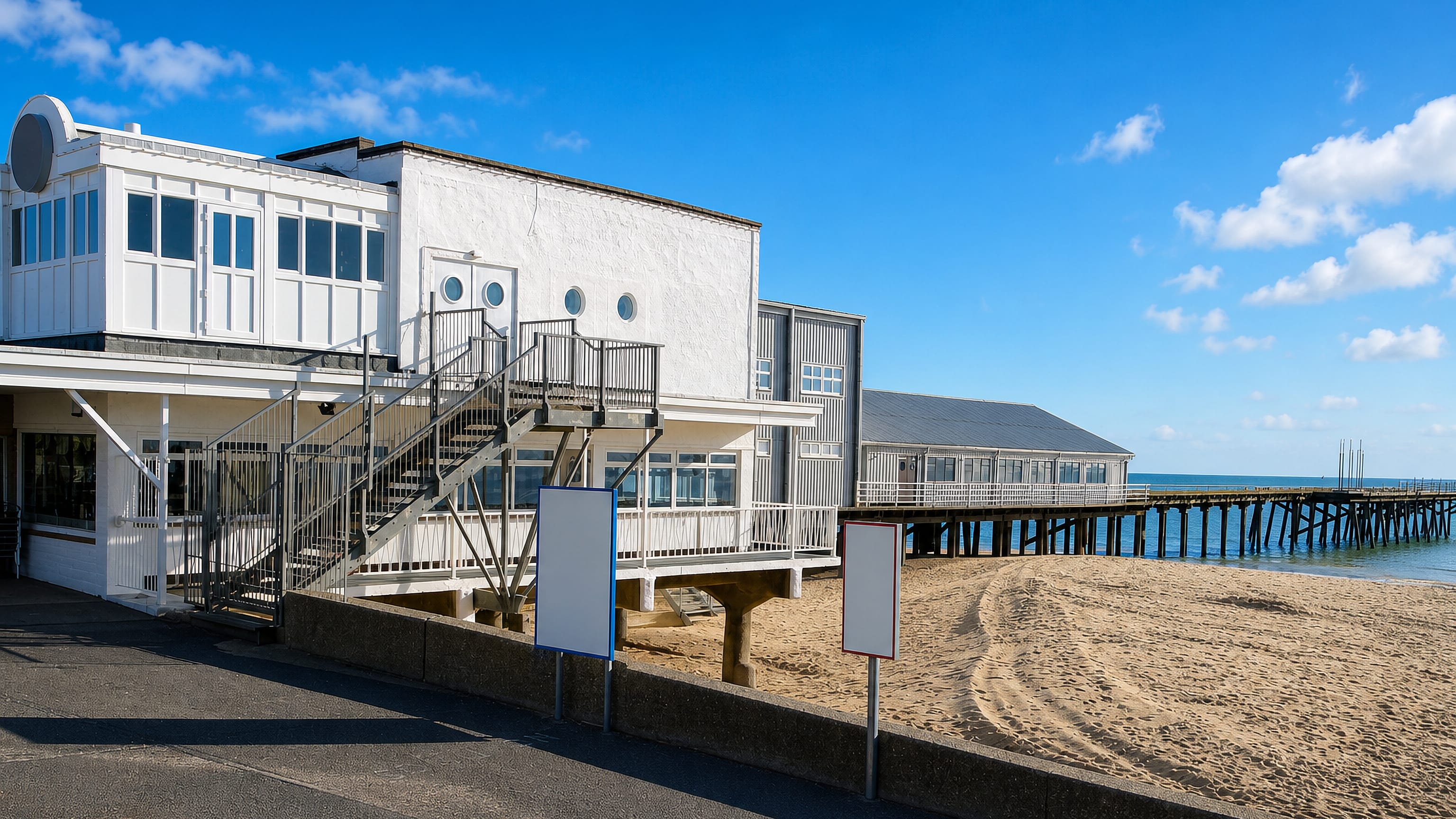 White seafront pavilion and pier stretching over the sand at Kirkley on Lowestoft's south beach.